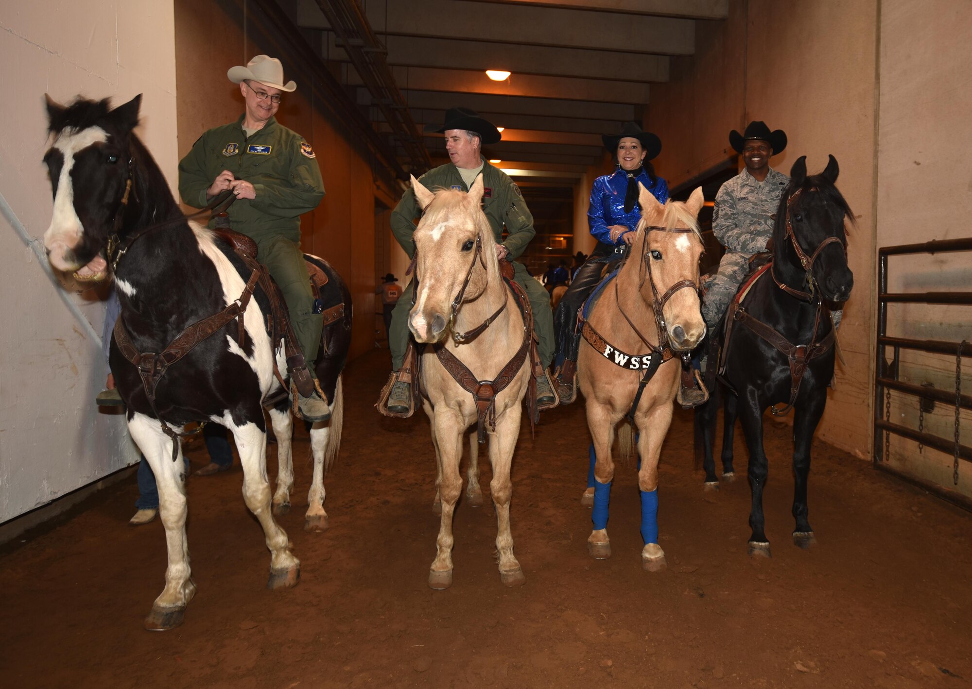 (Left to right) Col. Stephen Seaman, 301st Fighter Wing Director of Staff, Col. Gregory Jones, 301 FW commander, and (far right) Chief Master Sgt. Terry Goines, 301 FW Command Chief, prepare to ride in the Grand Entry 30 January 2017, in Fort Worth, Texas, supporting Military Appreciation Day at the rodeo. For 121 years, the Stock Show has been a vital link to Fort Worth’s “Cowtown” heritage and, for over a decade, an annual venue to thank military stationed all over Texas. (U.S. Air Force photos by Ms. Julie Briden-Garcia)