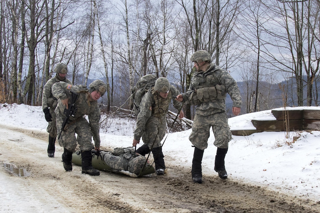 Army National Guard soldiers transport a mock casualty on a stretcher during a live-fire exercise at Camp Ethan Allen Training Site, Jericho, Vt., Jan. 26, 2017. Army National Guard photo by Spc. Avery Cunningham 