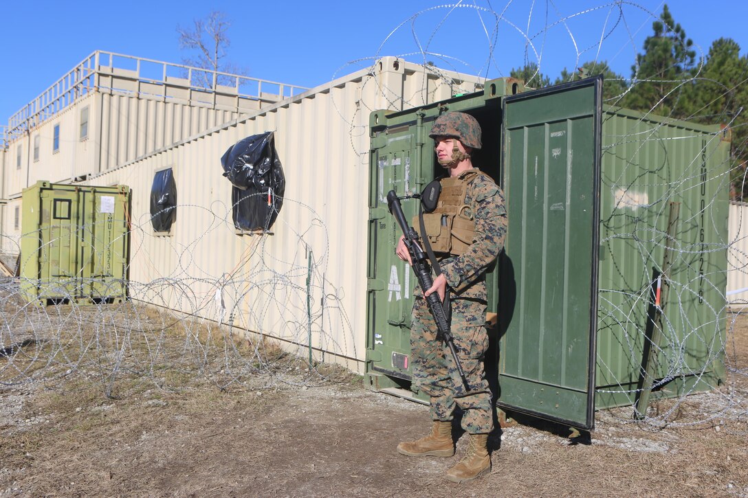 Lance Cpl. Bailey Hammanreichel stands guard in front the temporary special compartmentalized information facility at Camp Lejeune, N.C., Jan. 25, 2017. Marines with Alpha Co., 2nd Radio Battalion are participating in an embassy reinforcement exercise in order to prepare for a Special Purpose Marine Air-Ground Task Force. Hammanreichel is a ground electronics telecommunications and information technology systems maintainer with the company. (U.S. Marine Corps Photo by Cpl. Shannon Kroening)