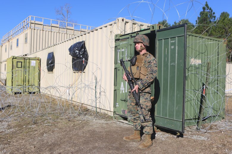 Lance Cpl. Bailey Hammanreichel stands guard in front the temporary special compartmentalized information facility at Camp Lejeune, N.C., Jan. 25, 2017. Marines with Alpha Co., 2nd Radio Battalion are participating in an embassy reinforcement exercise in order to prepare for a Special Purpose Marine Air-Ground Task Force. Hammanreichel is a ground electronics telecommunications and information technology systems maintainer with the company. (U.S. Marine Corps Photo by Cpl. Shannon Kroening)