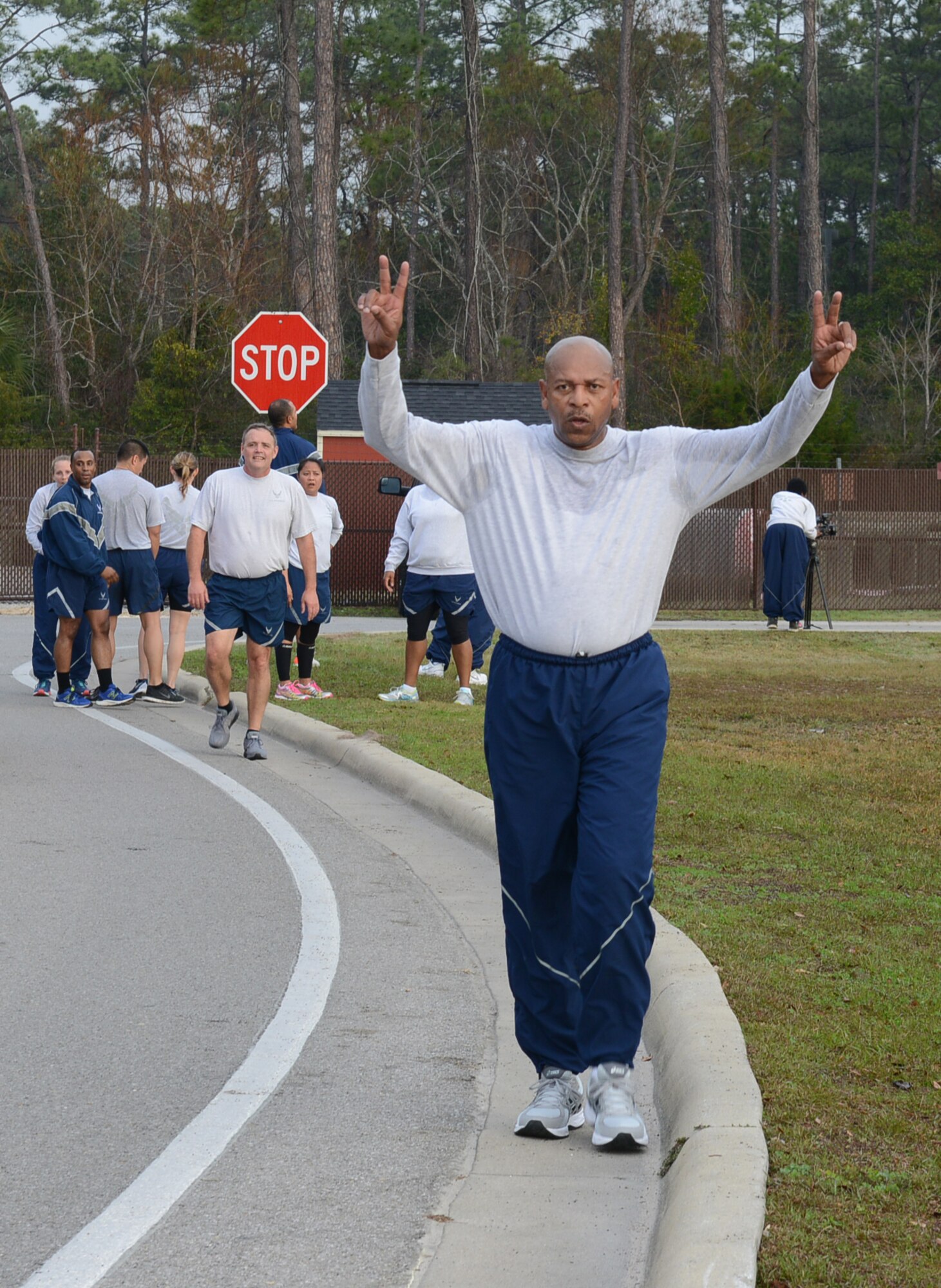Chief Master Sgt. Kerry Henderson, Air Force Special Operations Command communications and information chief, celebrates after completing a 5K run at Hurlburt Field, Fla., Feb. 3, 2017. (U.S. Air Force photo/Staff Sgt. Melanie Holochwost)