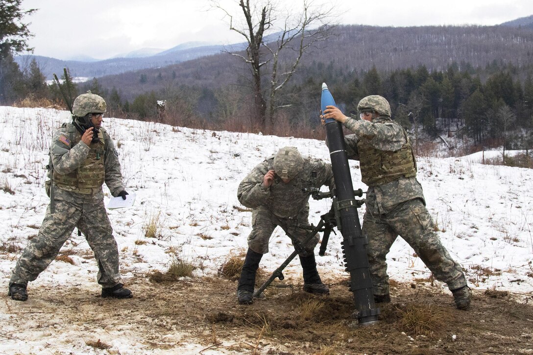 Army National Guard Army Sgt. Noah Nelson, left, receives a fire mission while Sgt. Jonah Breer, center, and Pfc. Nadeem Shedyak, prepare to fire a 120 mm mortar system during a live-fire exercise at Camp Ethan Allen Training Site, Jericho, Vt., Jan. 26, 2017. Nelson, Breer and Shedyak are assigned to the Vermont Army National Guard’s Headquarters Company, 3rd Battalion, 172nd Infantry Regiment, 86th Infantry Brigade Combat Team (Mountain). Army National Guard photo by Spc. Avery Cunningham 