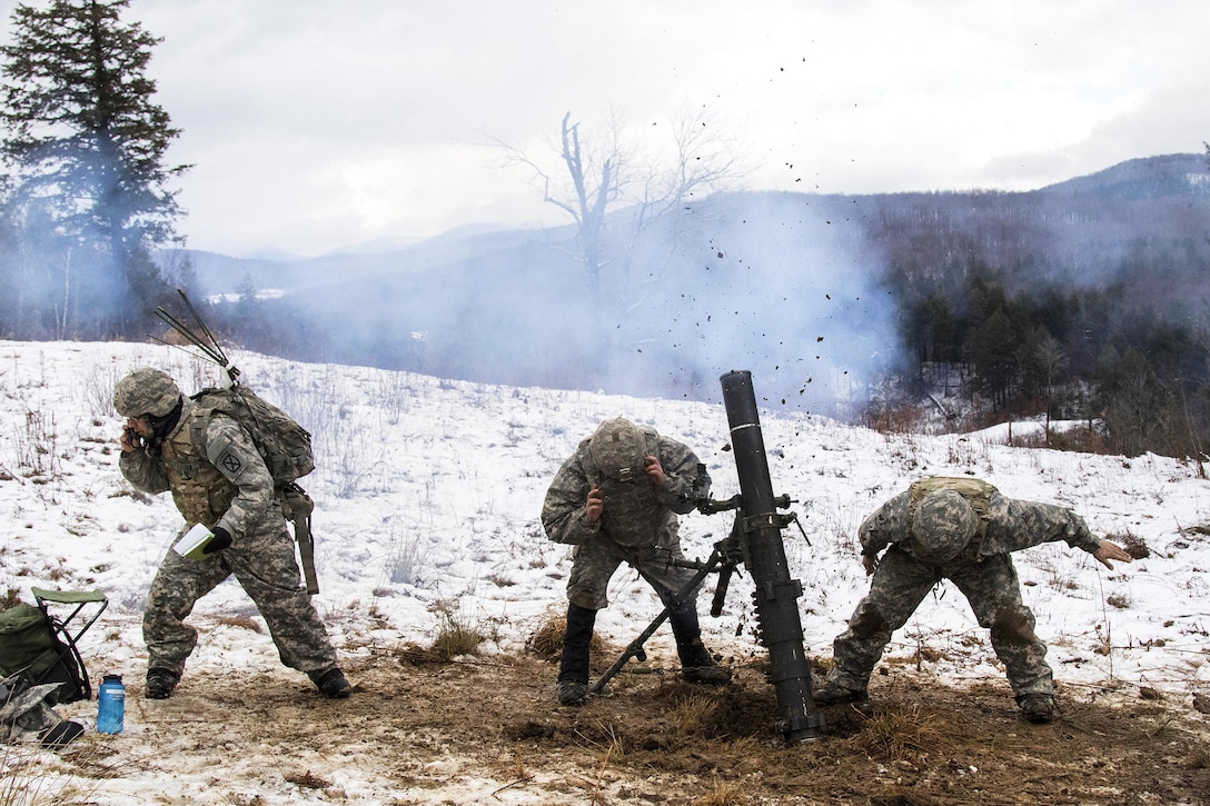 Army National Guard Army Sgt. Noah Nelson, left, receives a fire mission while Sgt. Jonah Breer, center, and Pfc. Nadeem Shedyak, fire a 120 mm mortar system during a live-fire exercise at Camp Ethan Allen Training Site, Jericho, Vt., Jan. 26, 2017. Nelson, Breer and Shedyak are assigned to the Vermont Army National Guard’s Headquarters Company, 3rd Battalion, 172nd Infantry Regiment, 86th Infantry Brigade Combat Team (Mountain). Army National Guard photo by Spc. Avery Cunningham