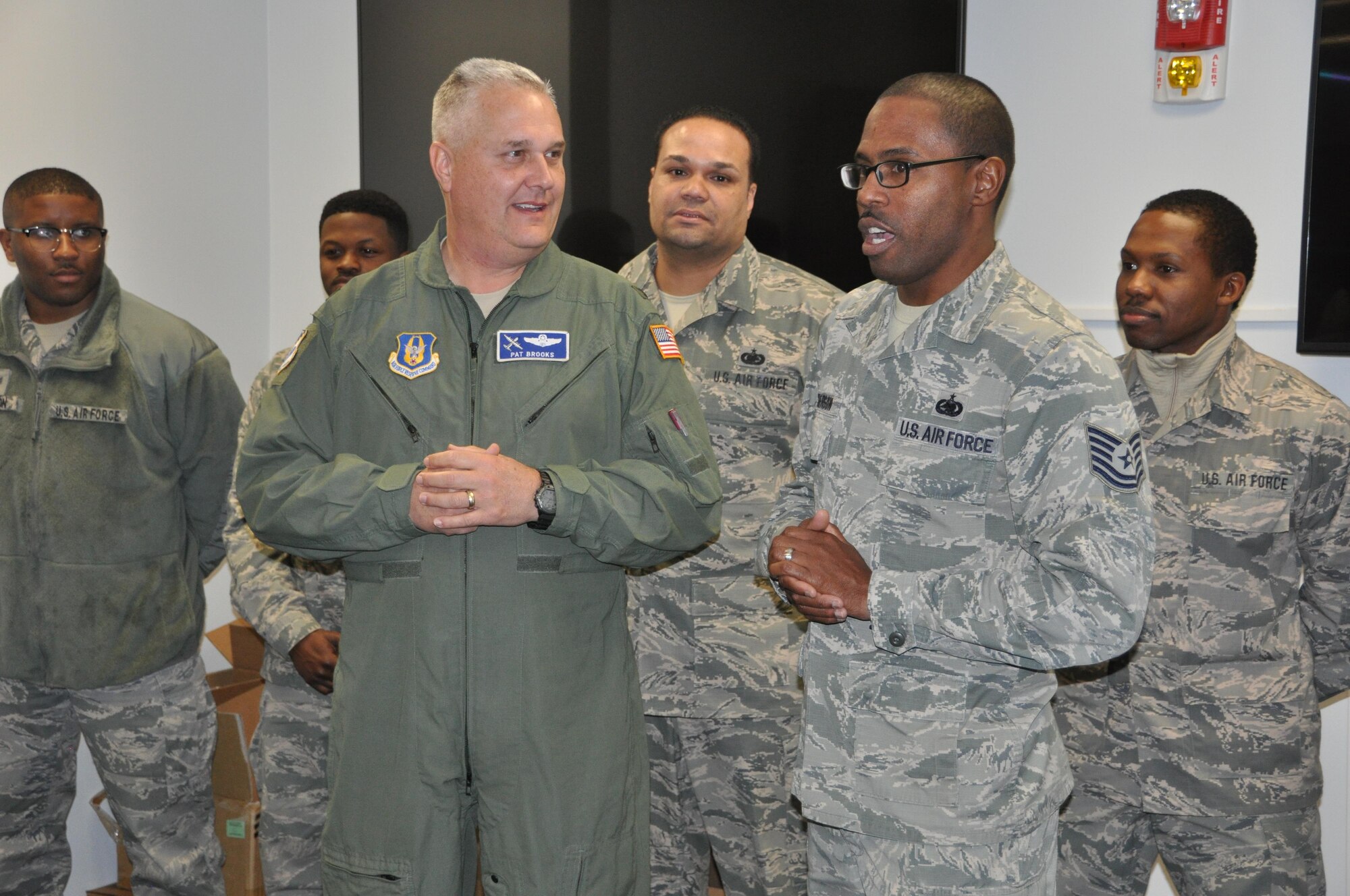 President of the 56'ers Group, Tech. Sgt. Earl Dickerson (Right) speaks to the 908th Airlift Wing's senior leaders before presenting a challenge coin to Wing Commander, Col. Pat Brooks (Left) during a ceremony Jan. 8. The 56'ers Group coined the wing commander, command chief, and the group commanders to show appreciation for all of the support the 56'ers have received from the wing's senior leaders. (U.S. Air Force photo by Bradley J. Clark)