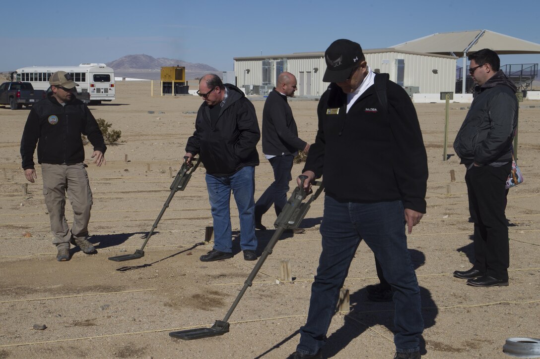 Members of the Drug Enforcement Administration Citizens’ Academy Alumni Association learn how to sweep for improvised explosive devices at Range 800 aboard Marine Corps Air Ground Combat Center, Twentynine Palms, Calif., Jan. 26, 2017. (U.S. Marine Corps photo by Cpl. Connor Hancock)