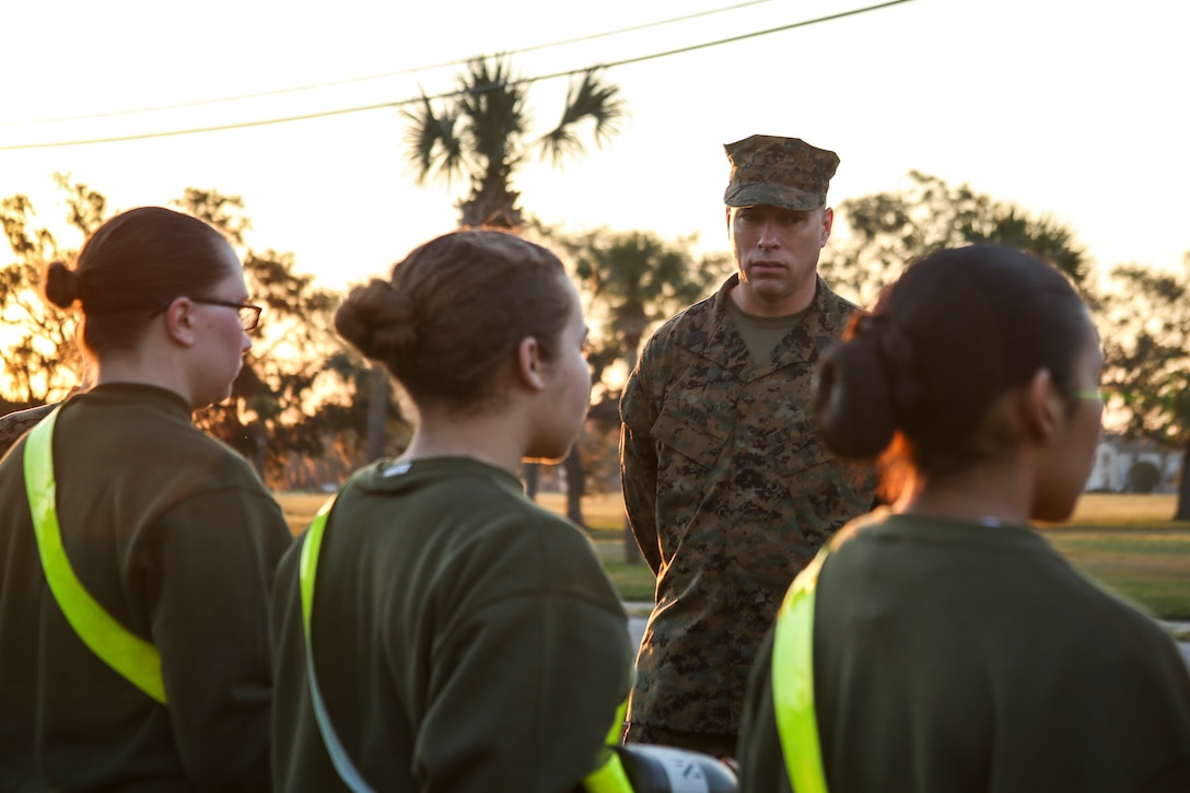 Master Sergeant Paul E. Davis Jr., recruiter instructor of Recruiting Station Jacksonville, 6th Marine Corps District, speaks to recruits after an Initial Strength Test (IST) during the 8412 Slating Conference aboard Marine Corps Recruit Depot Parris Island, South Carolina, Feb. 3, 2017. The Slating Conference brings the recruiting command together to discuss the movement of their Marines across recruiting stations. A Marine holding the military occupational specialty of 8412 is known as a career recruiter. These recruiters use the IST to assist them in the training and mentoring of future Marines. (U.S. Marine Corps photo by Lance Cpl. Jack A. E. Rigsby/Released)