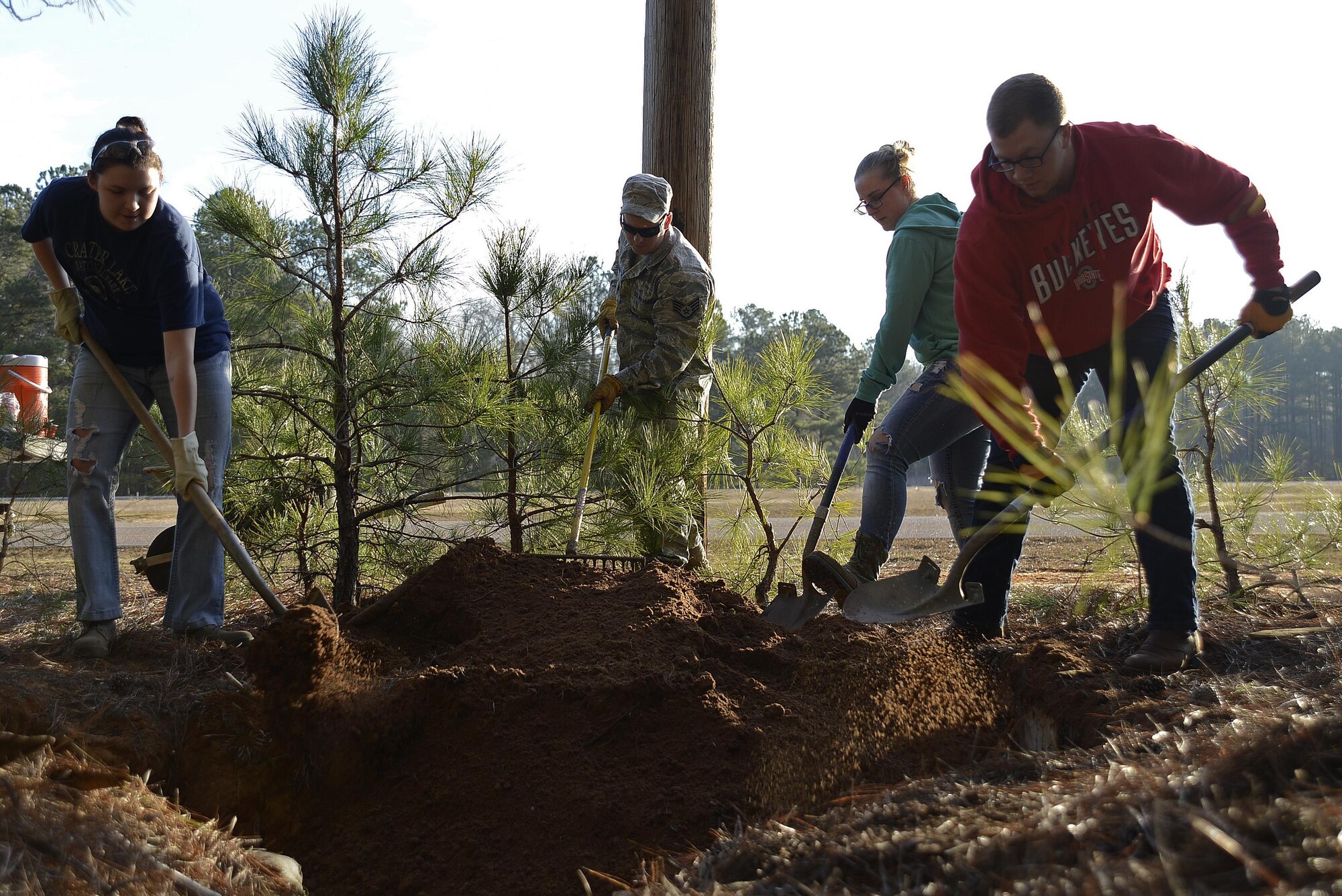Team Shaw members shovel dirt into a defensive fighting position hole at Shaw Air Force Base, S.C., Feb. 1, 2017. The DFPs were built approximately 15 years ago for training exercises, but are no longer used. (U.S. Air Force photo by Airman 1st Class BrieAnna Stillman)