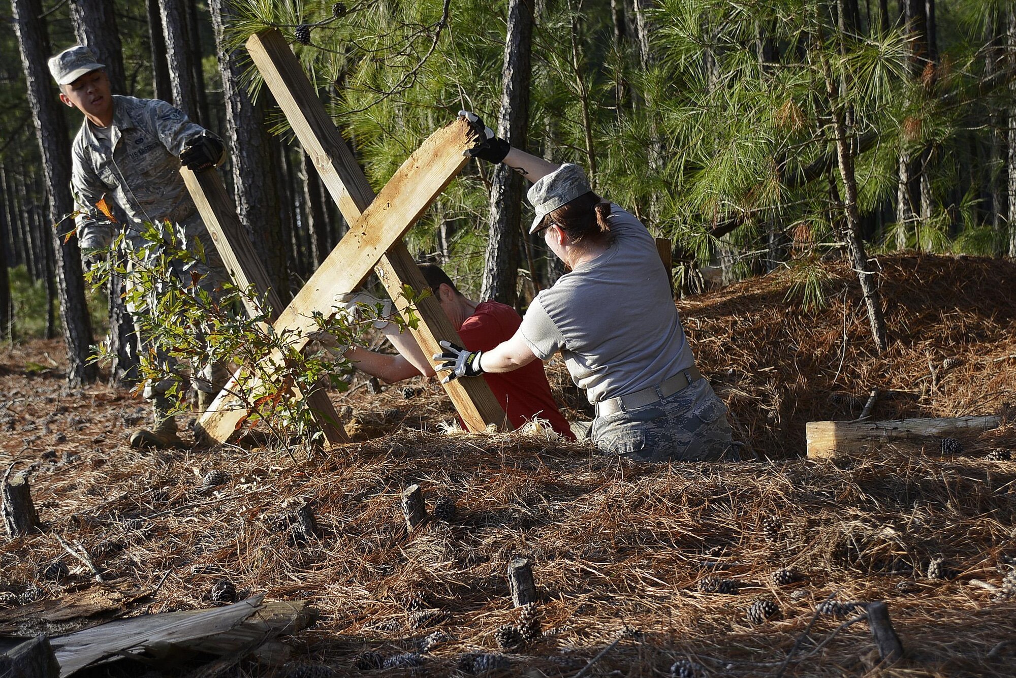 Team Shaw members work together to take apart a defensive fighting position during a beautification project at Shaw Air Force Base, S.C., Feb. 1, 2017. The DFP was used in exercises for personnel deploying downrange, giving them the training to take cover in a shelter and the ability to shoot the enemy. (U.S. Air Force photo by Airman 1st Class BrieAnna Stillman)