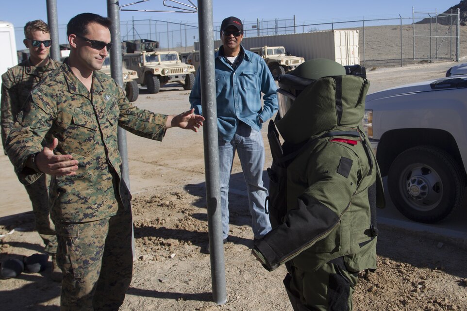 Sgt. Alex Strait, explosive ordnance disposal (EOD) technician, Combat Center EOD, teaches a member of the Drug Enforcement Administration Citizens’ Academy Alumni Association how to move in an EOD bomb suit aboard Marine Corps Air Ground Combat Center, Twentynine Palms, Calif., Jan. 26, 2017. (U.S. Marine Corps photo by Cpl. Connor Hancock)