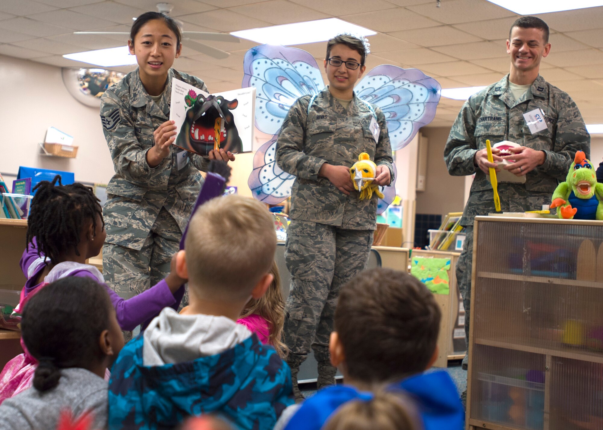 From left, Staff Sgt. Soohwa Ono, Senior Airman Vanessa Rivas, and Capt. Daniel Chartrand promote pediatric oral hygiene Feb. 2 at the Kelly Child Development Center. Throughout February, the 59th Dental Group is holding outreach events at the Joint Base San Antonio-Lackland Elementary School and child development centers. Ono and Rivas are 59th DG dental technicians; Chartrand is a 59th DG dentist. (U.S. Air Force photo/Staff Sgt. Kevin Iinuma)