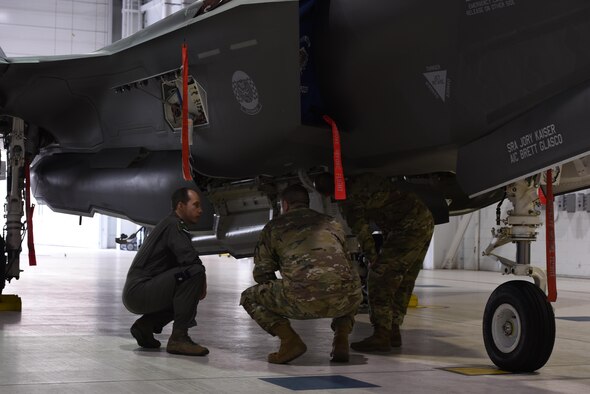 U.S. Air Force Lt. Col. Scott Gunn, 33rd Operations Support Squadron commander, left, discusses the weapons bay of an F-35A Lightning II with COL Samuel Saine, 4th Battlefield Coordination Detachment commander, center, and Sgt. Maj. Miguel Quiros, 4 BCD sergeant major, right, Jan. 26, 2017, at Eglin Air Force Base, Florida. Saine and Qurios visited the 33rd Fighter Wing while conducting a battlefield circulation analysis to engage with and evaluate Ground Liaison Officers embedded in the unit. (U.S. Air Force photo by Staff Sgt. Peter Thompson)