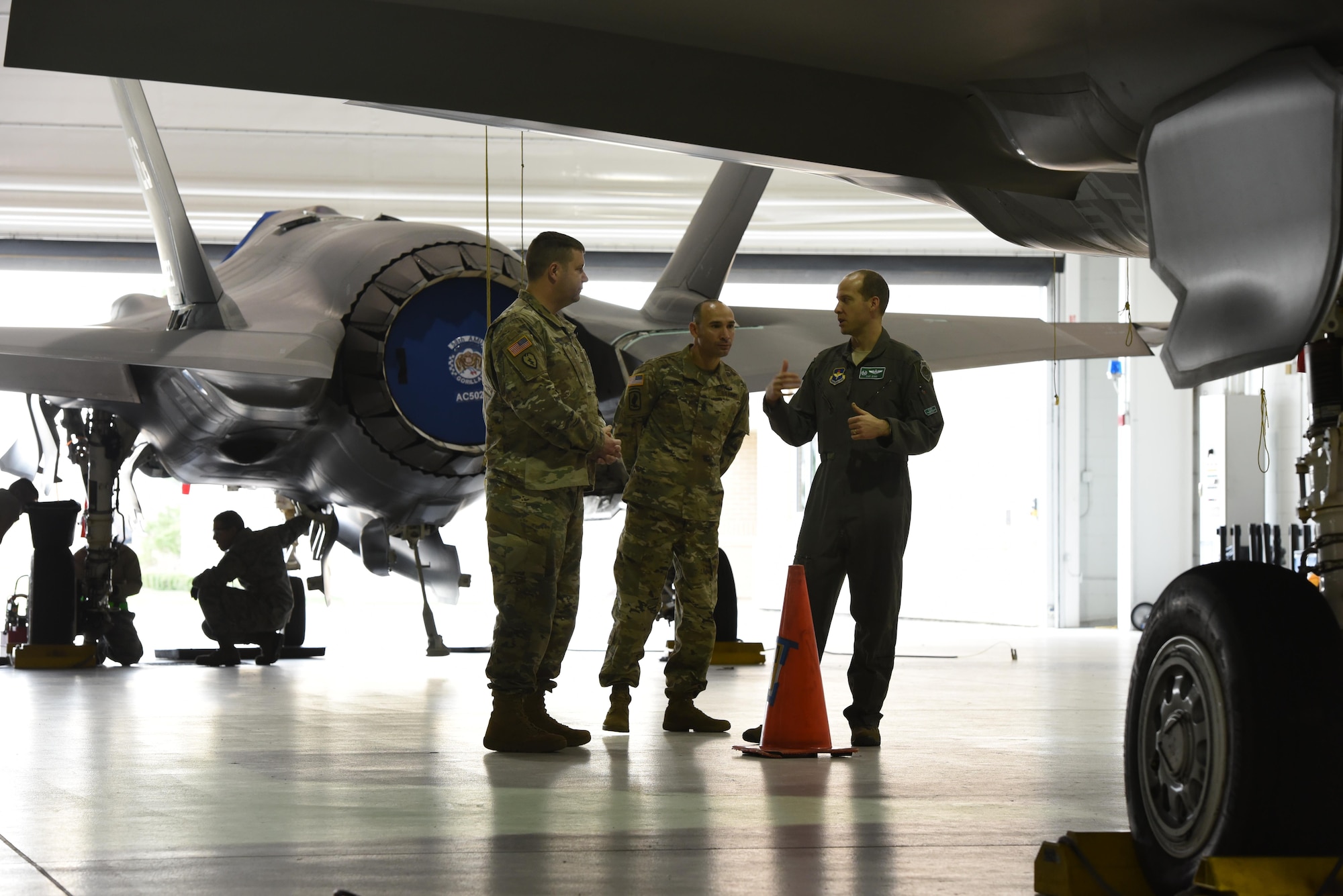 U.S. Air Force Lt. Col. Scott Gunn, 33rd Operations Support Squadron commander, right, discusses the weapons bay of an F-35A Lightning II with COL Samuel Saine, 4th Battlefield Coordination Detachment commander, left, and Sgt. Maj. Miguel Quiros, 4 BCD sergeant major, center, Jan. 26, 2017, at Eglin Air Force Base, Florida. Saine and Qurios visited the 33rd Fighter Wing while conducting a battlefield circulation analysis to engage with and evaluate Ground Liaison Officers embedded in the unit. (U.S. Air Force photo by Staff Sgt. Peter Thompson)