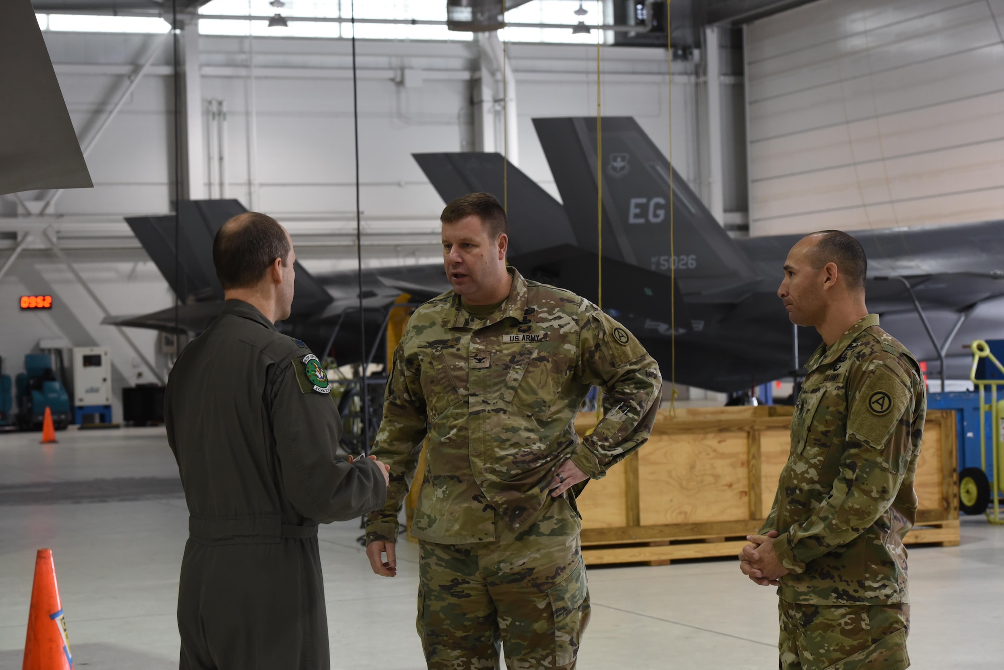 U.S. Air Force Lt. Col. Scott Gunn, 33rd Operations Support Squadron commander, left, discusses the weapons bay of an F-35A Lightning II with COL Samuel Saine, 4th Battlefield Coordination Detachment commander, center, and Sgt. Maj. Miguel Quiros, 4 BCD sergeant major, right, Jan. 26, 2017, at Eglin Air Force Base, Florida. Saine and Qurios visited the 33rd Fighter Wing while conducting a battlefield circulation analysis to engage with and evaluate Ground Liaison Officers embedded in the unit. (U.S. Air Force photo by Staff Sgt. Peter Thompson)