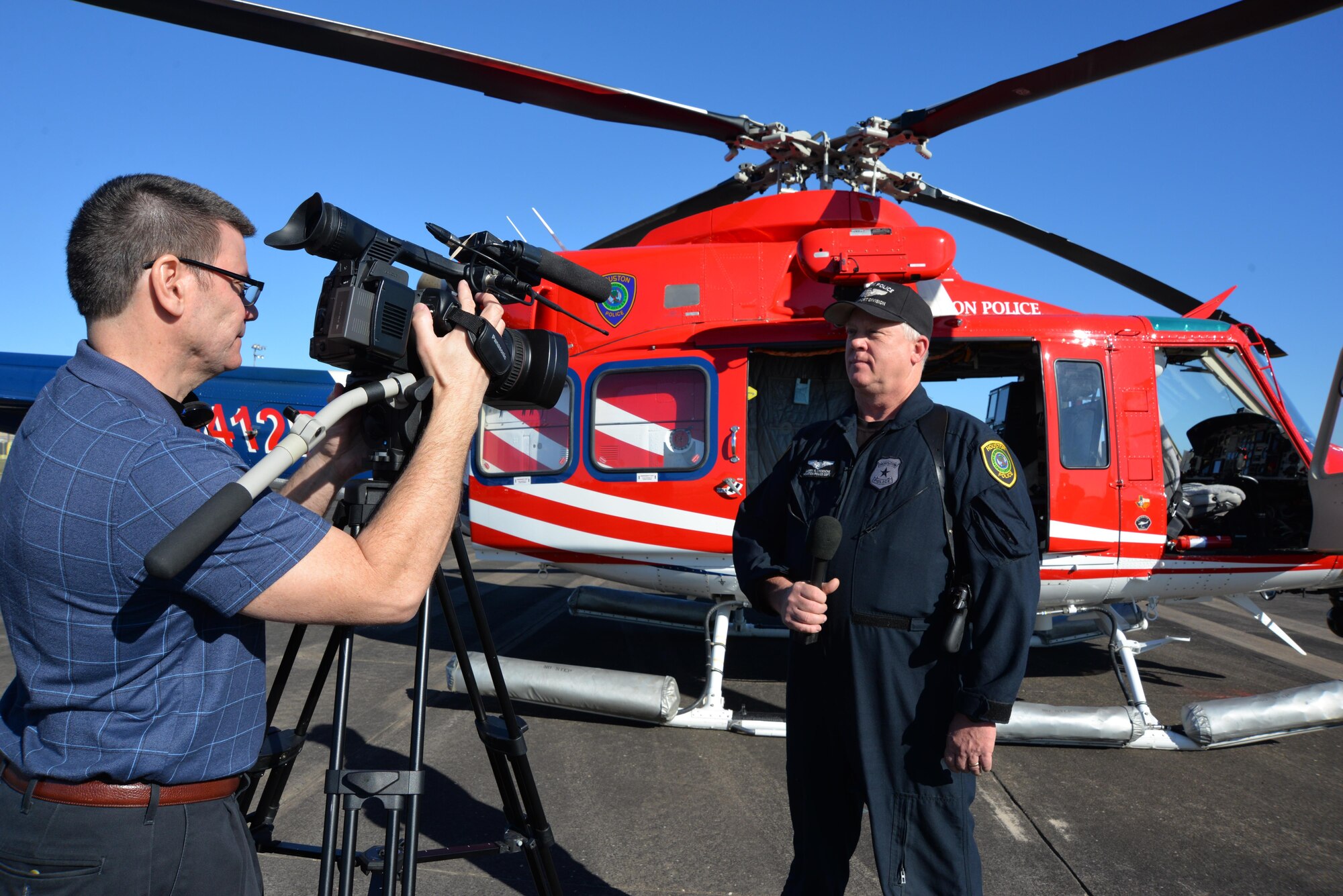 Louis Biehslich, 101st Air Communications Squadron videographer, films an interview with Larry Kroesche, chief pilot, Houston Police Department Air Operations, during a Super Bowl LI aerospace-security related media day Jan. 31 at Ellington Field Joint Reserve Base, Houston, Texas. As part of the media day, representatives from several agencies came together to speak about their roles in helping support air defense during Super Bowl LI Feb. 5. (Photo released by Mary McHale)
