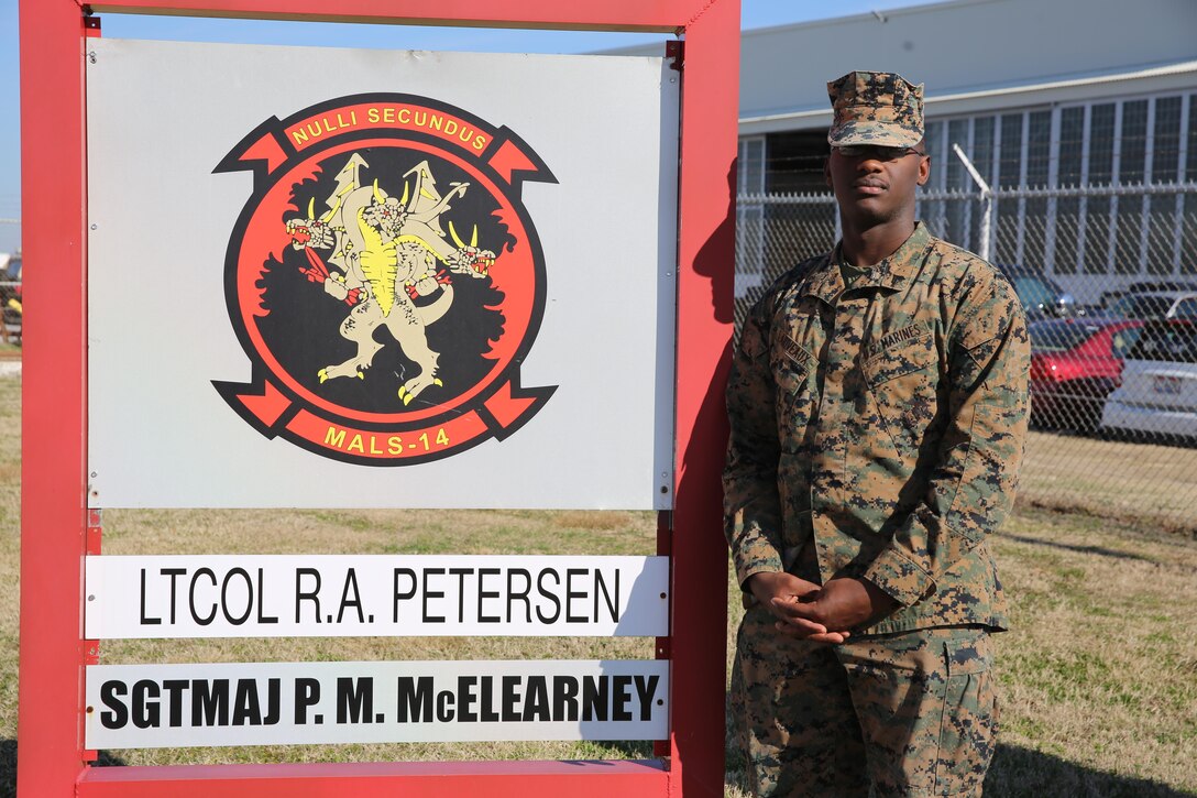 Cpl. Wilde Lariveaux, stands beside his squadrons sign aboard Marine Corps Air Station Cherry Point, N.C., Feb. 1, 2017. Lariveaux emigrated from Haiti to the United States when he was seven years old. Several years later he went back to Haiti to lend humanitarian aid to the country after the decimation of Hurrican Matthew. Lariveaux is an administrative specialist assigned to Marine Aviation Logistics Squadron 14, Marine Aircraft Group 14, 2nd Marine Aircraft Wing. (U.S. Marine Corps photo by Lance Cpl. Cody Lemons/Released)