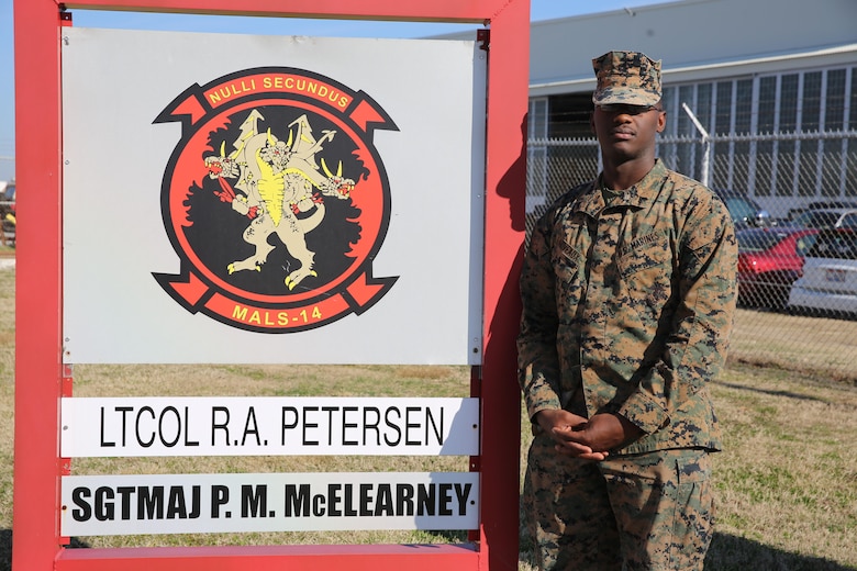 Cpl. Wilde Lariveaux, stands beside his squadrons sign aboard Marine Corps Air Station Cherry Point, N.C., Feb. 1, 2017. Lariveaux emigrated from Haiti to the United States when he was seven years old. Several years later he went back to Haiti to lend humanitarian aid to the country after the decimation of Hurrican Matthew. Lariveaux is an administrative specialist assigned to Marine Aviation Logistics Squadron 14, Marine Aircraft Group 14, 2nd Marine Aircraft Wing. (U.S. Marine Corps photo by Lance Cpl. Cody Lemons/Released)