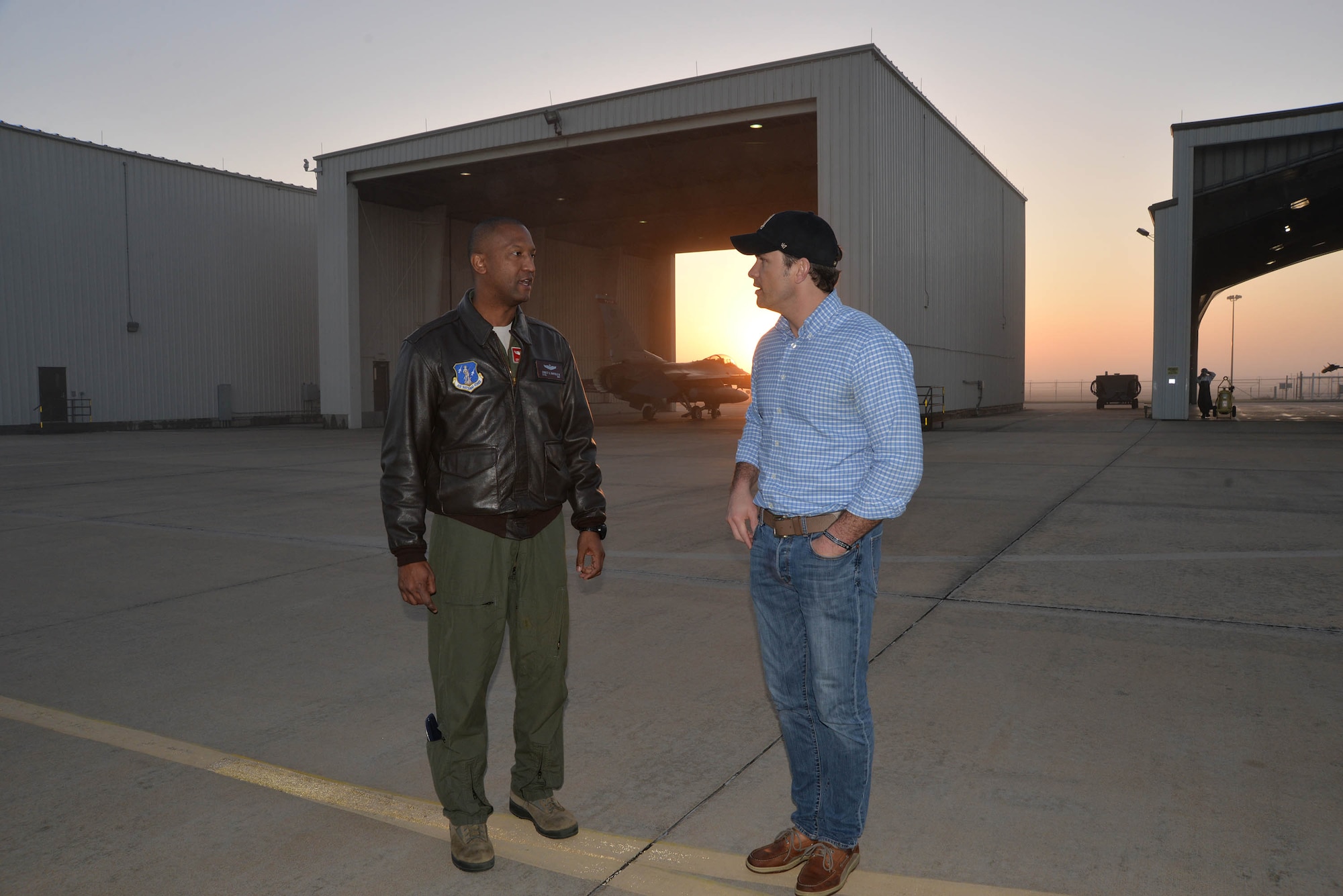 Lt. Col. Ernie Mayfield, Director of Operations, 138th Fighter Wing, Det. 1, talks with Peter Hegseth, Fox & Friends television news contributor, as day breaks during the morning of Hegseth’s aerospace defense familiarization flight. Hegseth flew with the unit as part of a Continental Aerospace Defense Region communications outreach plan to help enhance public knowledge about temporary flight restrictions during high-profile events such as Super Bowl LI. (Photo released by Mary McHale)