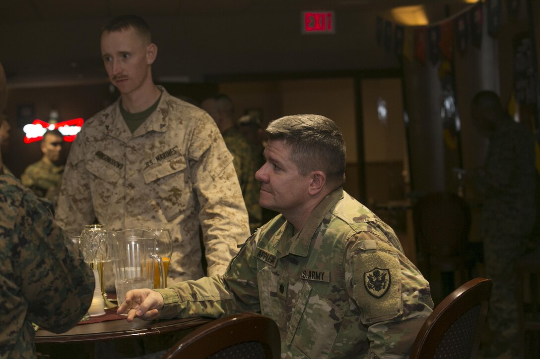 Army Lt. Col. Scott Applegate, deputy branch chief, Cyber Policy Branch, Strategic Plans and Policies, talks with Marine Corps Communication-Electronics School leadership at Frontline Restaurant aboard Marine Corps Air Ground Combat Center, Twentynine Palms, Calif., Jan. 30, 2017. (Marine Corps photo by Cpl. Thomas Mudd)