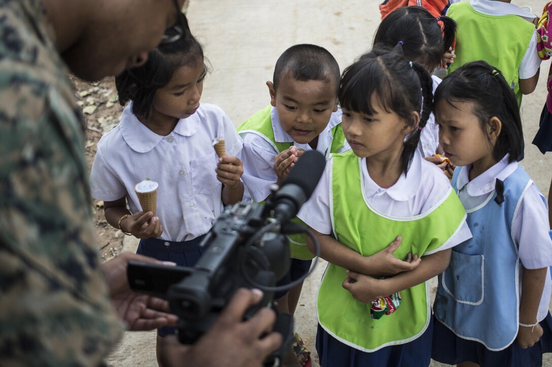 Marine Corps Lance Cpl. Justin Dixon records video of children at the Ban Non Lueam School during exercise Cobra Gold in Korat, Thailand, Feb. 2, 2017. Cobra Gold is the largest annual multilateral exercise in Asia. Marine Corps photo by Staff Sgt. Nathan O. Sotelo