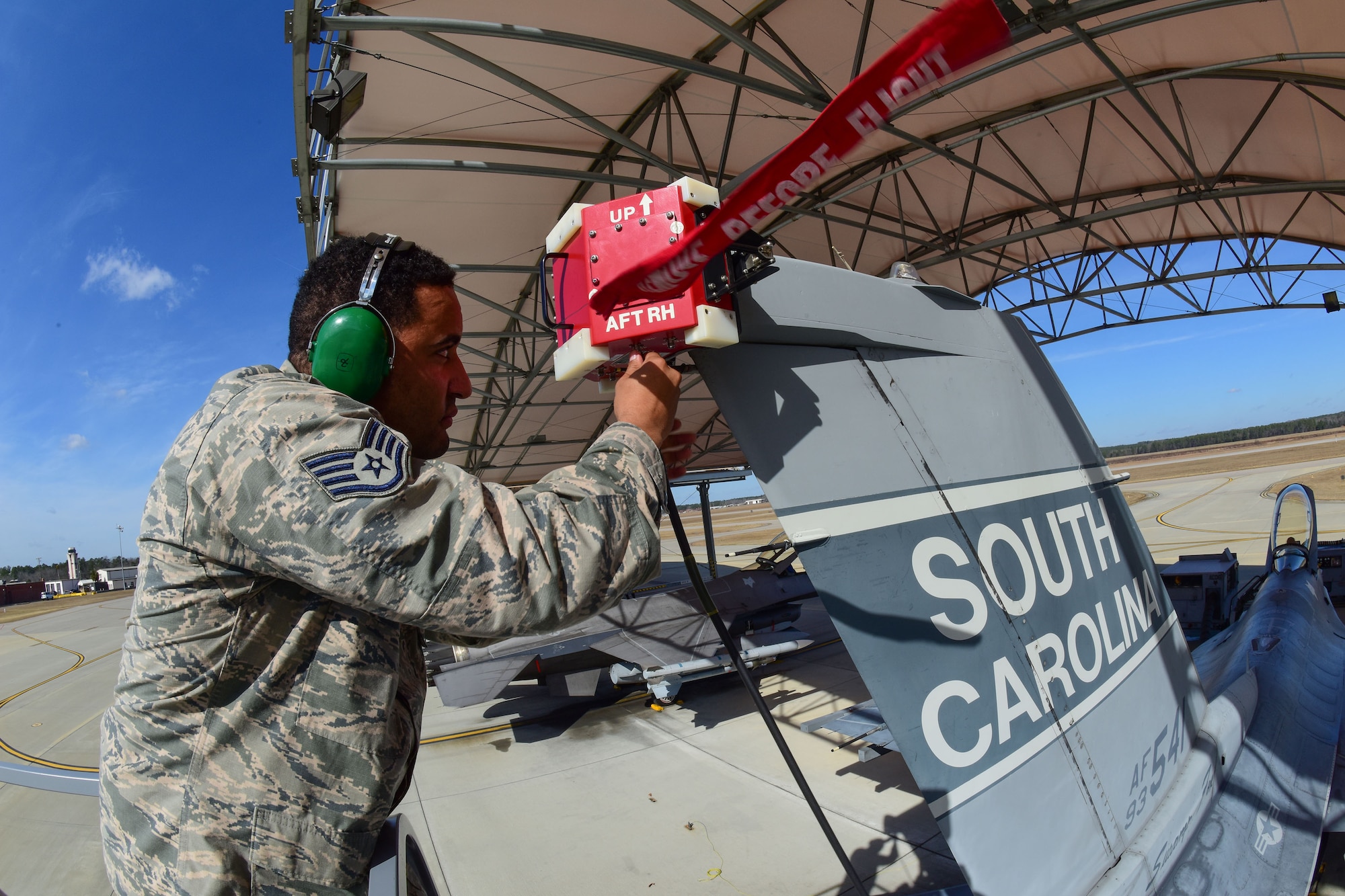 U.S. Air Force Staff Sgt. Allen Greenhill, a Combat Shield inspector from the 16th Electronic Warfare Squadron at Eglin Air Force Base, Fla., attaches a testing device onto an F-16 Fighting Falcon assigned to the South Carolina Air National Guard at McEntire Joint National Guard Base, S.C., Jan. 18, 2017. The South Carolina Air National Guard’s 169th Aircraft Maintenance Squadron’s F-16 Avionics shop received its annual Combat Shield evaluation. Combat Shield evaluates the reliability of the jet’s radar threat warning system, electronic countermeasure, and high-speed anti-radiation missile targeting system pods. Each component is crucial to the success of the F-16 fighter pilot in combat situations.  (U.S. Air National Guard photo by Airman 1st Class Megan Floyd)