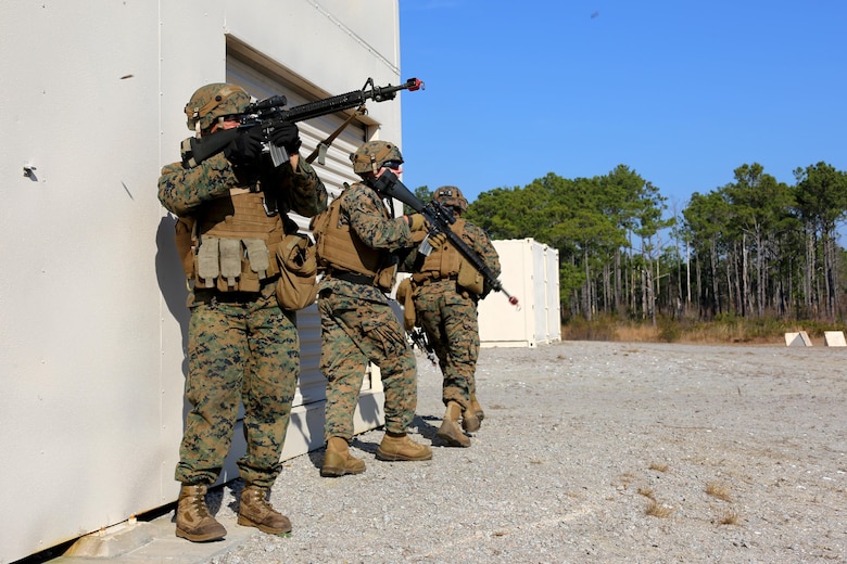 Marines provide security while maneuvering around a building during Military Operations in Urban Terrain training aboard Marine Corps Outlying Field Atlantic, N.C., Feb. 2, 2017. Nearly 40 Marines with supporting personnel participated in the weeklong training that simulated hostile takeovers and how to overcome unexpected situations with small unit leadership. The Marines are assigned to Marine Wing Support Squadron 271, Marine Aircraft Group 14, 2nd Marine Aircraft Wing. (U.S. Marine Corps photo by Cpl. Jason Jimenez/ Released)