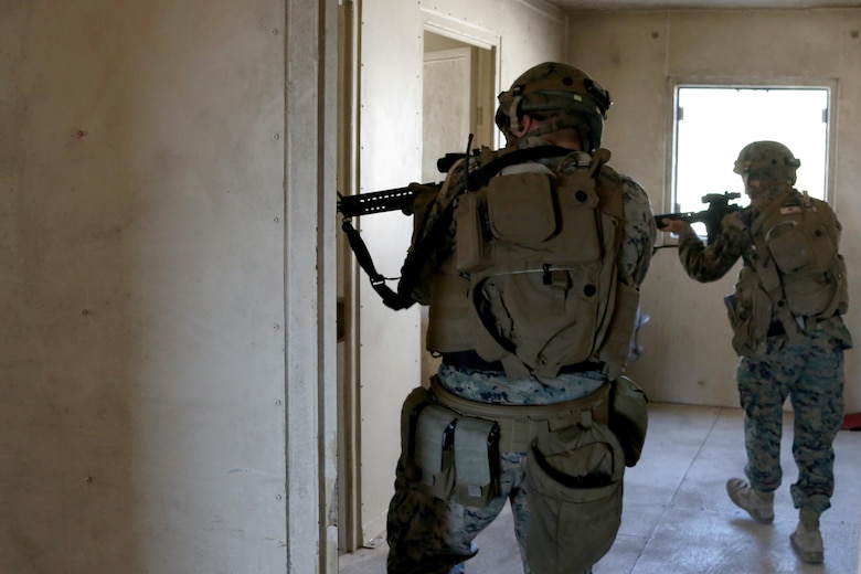 Marines clear a building during Military Operations in Urban Terrain training aboard Marine Corps Outlying Field Atlantic, N.C., Feb. 2, 2017. Nearly 40 Marines with supporting personnel participated in the weeklong training that simulated hostile takeovers and how to overcome unexpected situations with small unit leadership. “My end goal is to ensure any of my Marines are able to take my place if the situation arises,” said Cpl. Christian Leishman, a squad leader for the exercise. The Marines are assigned to Marine Wing Support Squadron 271, Marine Aircraft Group 14, 2nd Marine Aircraft Wing. (U.S. Marine Corps photo by Cpl. Jason Jimenez/ Released)