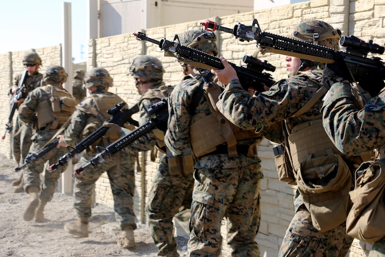 Marines stack and maneuver around a wall during Military Operations in Urban Terrain training aboard Marine Corps Outlying Field Atlantic, N.C., Feb. 2, 2017. Marines stack themselves one after another as a tactical advantage for breaching a doorway. Nearly 40 Marines with supporting personnel participated in the weeklong training that simulated hostile takeovers and how to overcome unexpected situations with small unit leadership. The Marines are assigned to Marine Wing Support Squadron 271, Marine Aircraft Group 14, 2nd Marine Aircraft Wing. (U.S. Marine Corps photo by Cpl. Jason Jimenez/ Released)