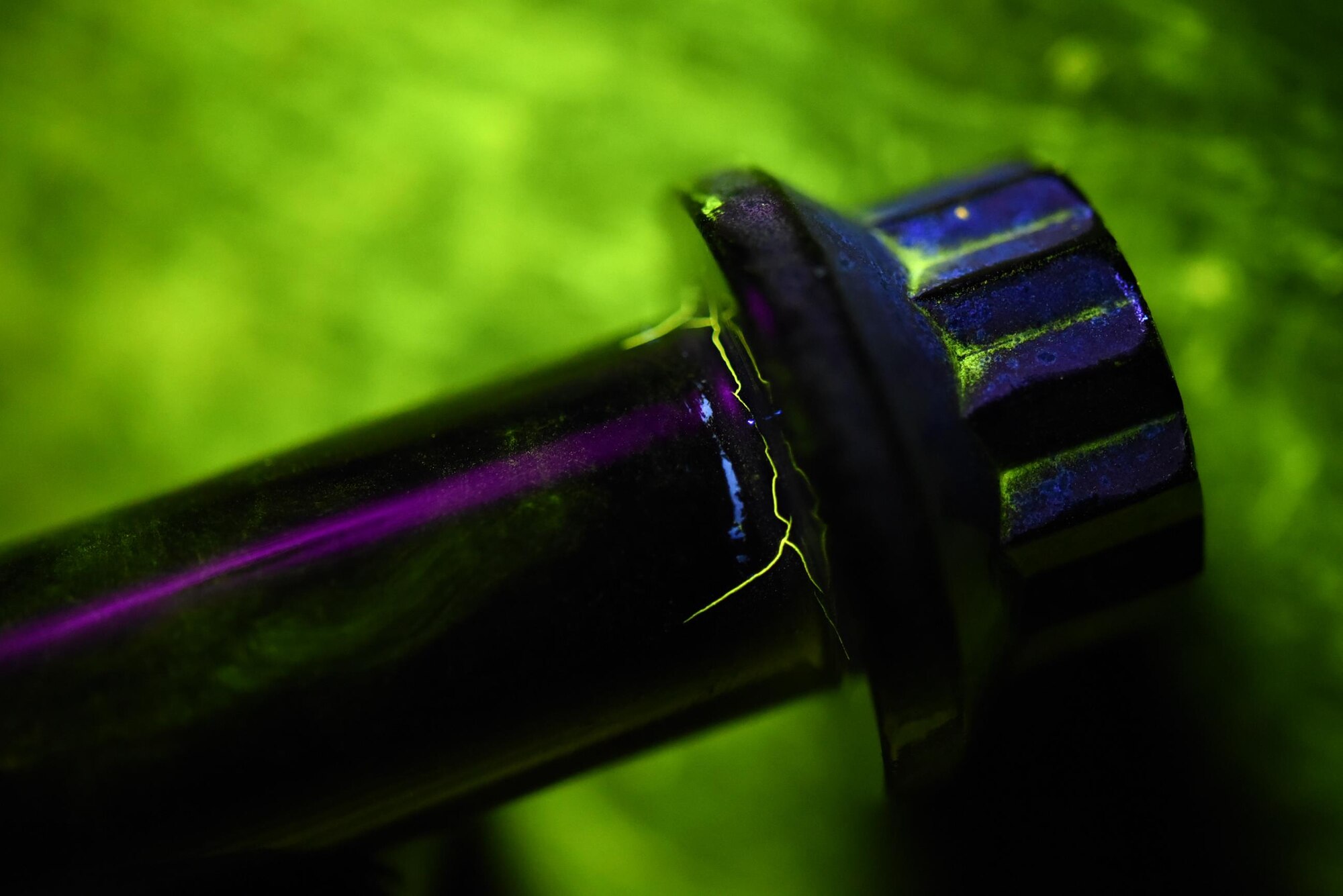 Cracks are made visible under black lights on a main landing wheel bolt Jan. 31, 2017, at Little Rock Air Force Base, Ark. When a crack is identified, it is documented, marked and returned to the original shop for further repair. (U.S. Air Force photo by Airman 1st Class Kevin Sommer Giron)