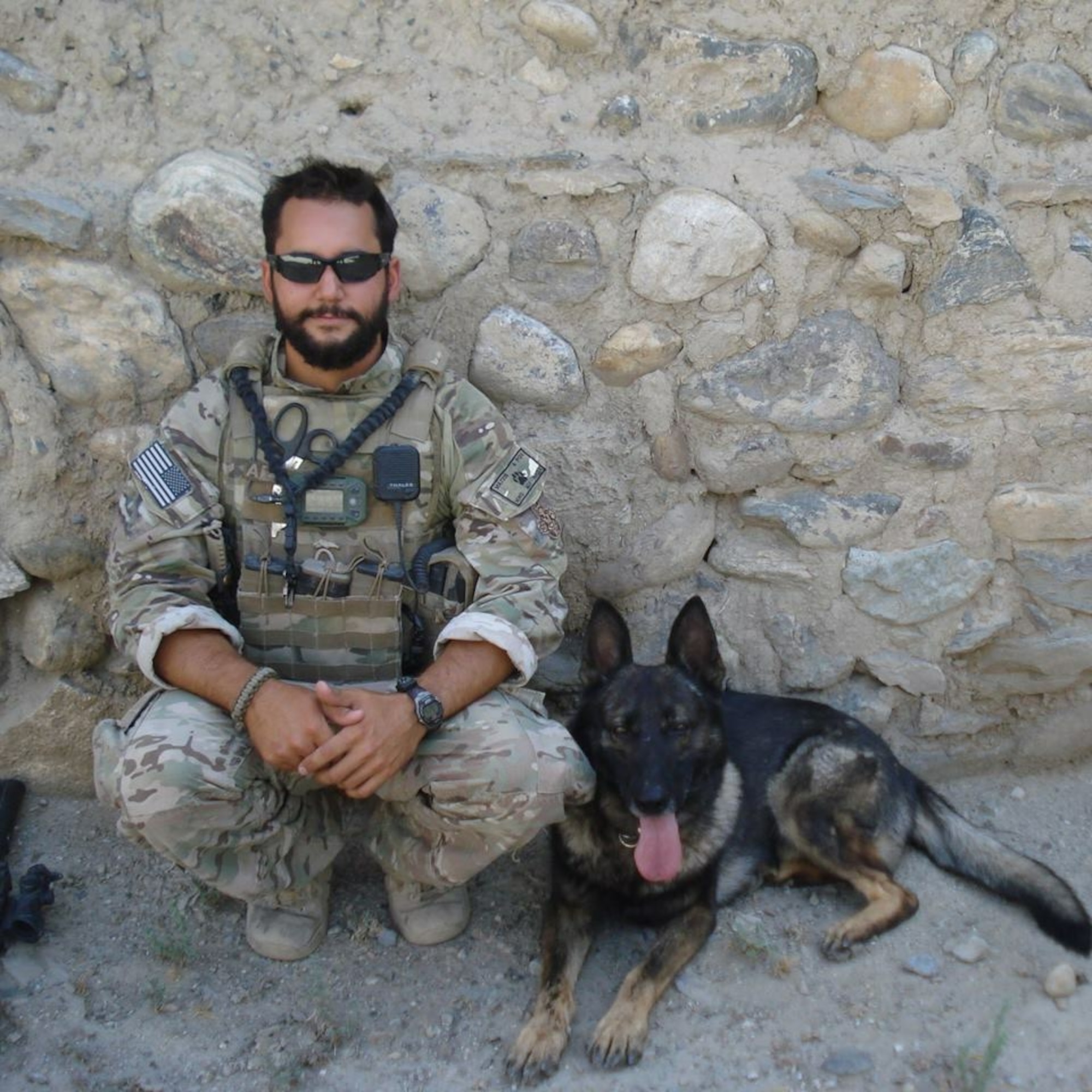 U.S. Air Force Staff Sgt. David Macdonald, dog handler, poses for a photo with military working dog Ali at Bagram Air Base, Afghanistan, in 2013. (Courtesy photo)