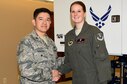 Col. Jerry Gonzalez, Air Education and Training Command Inspector General Chief of Inspection Division, gives a coin to Airman 1st Class Gabrielle Achuff, 14th Medical Operations Squadron Aerospace Operational Physiology technician, Jan. 30, 2017, in recognition of her efforts during the Unit Effectiveness Inspection at Columbus Air Force Base, Mississippi. Before the UEI, Col. Douglas Gosney, 14th Flying Training Wing Commander, stated how outstanding the team of Airmen, consisting of active duty, guard, reserve, civil service, non-appropriated fund employees, international partners, contractors, community partners, and families, does amazing things in order to accomplish our primary mission to Produce Pilots, Advance Airmen, and Feed the Fight. (U.S. Air Force photo by Elizabeth Owens)