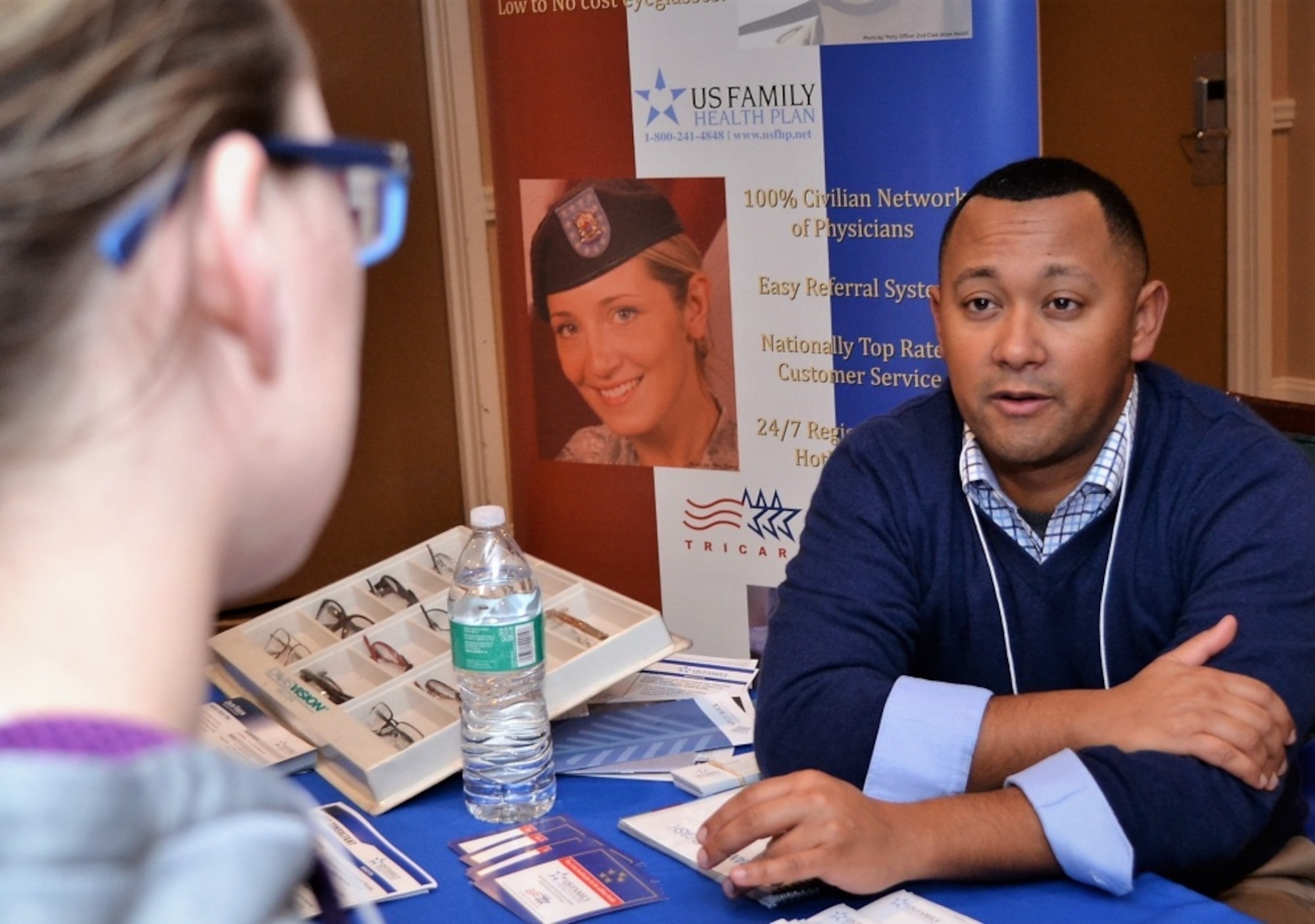 Wil Acosta, A former Marine who now represents US Family Health Plan, assists a 111th Attack Wing member during a pre-deployment Yellow Ribbon Reintegration Program event held in Carbon County, Pa. Jan. 7, 2017. Information booths were set up to assist program attendees in becoming aware of the resources available to them and their dependents. (U.S. Air National Guard photo by Tech. Sgt. Andria Allmond)