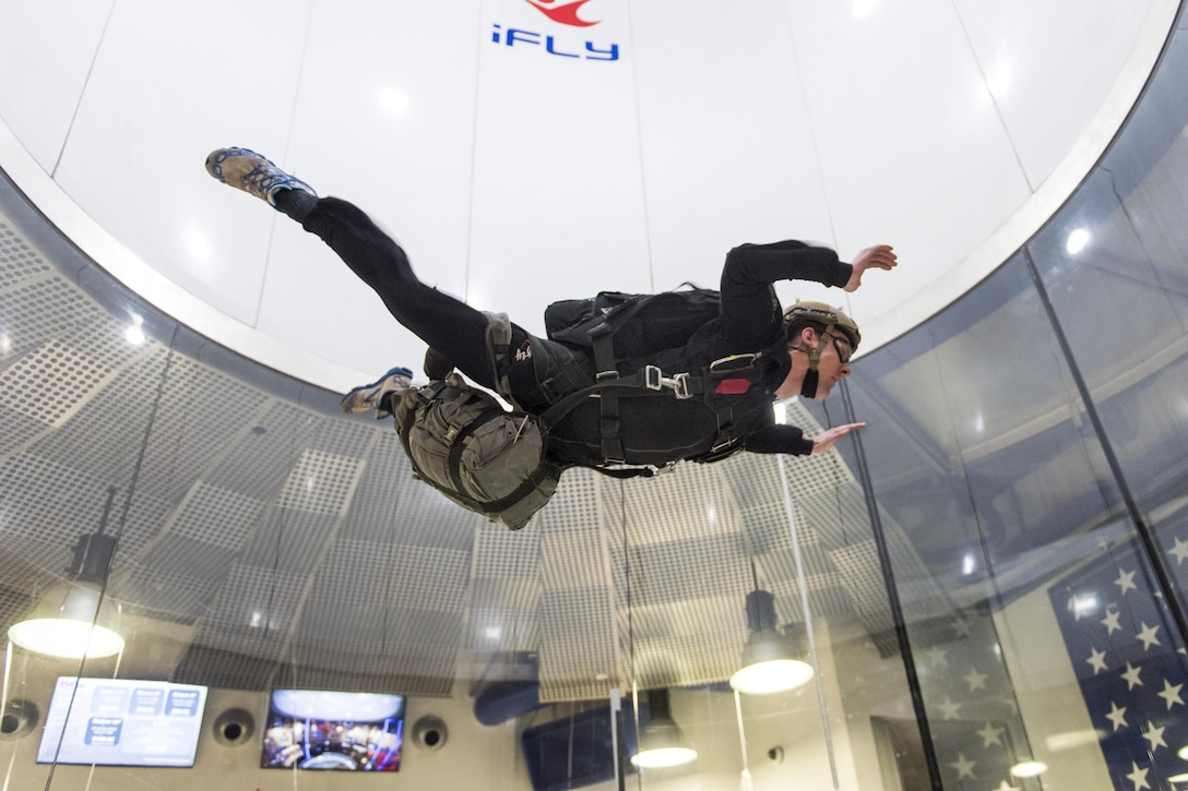 A sailor practices proper free fall technique during military training at a vertical wind tunnel facility in Virginia Beach, Va., Feb. 1, 2017. The sailor is assigned to Explosive Ordnance Disposal Group  2, which oversees all other similar units on the East Coast. Navy photo by Petty Officer 2nd Class Charles Oki