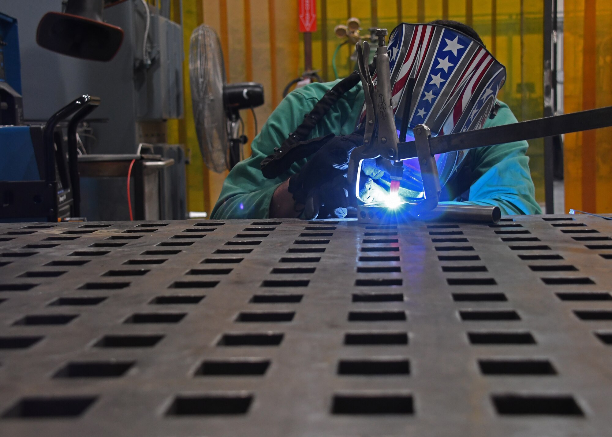 U.S. Air Force Staff Sgt. Eric Kerr, a fabrication flight metals technician with the 379th Expeditionary Maintenance Squadron, “tacks” pieces of metal together using a welder at Al Udeid Air Base, Qatar, Feb. 2, 2017. Tack-welding is used as a temporary means to hold components in the proper location, alignment, and distance apart until final welding can be completed, and is done by fusing the pieces together at a single point. (U.S. Air Force photo by Senior Airman Miles Wilson)