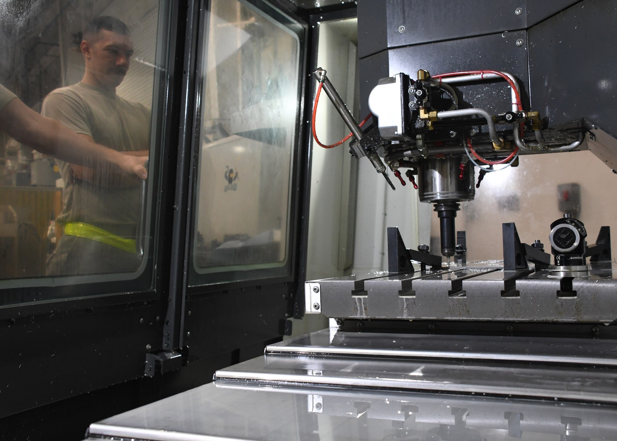 U.S. Air Force Staff Sgt. Eric Kerr, a fabrication flight metals technician with the 379th Expeditionary Maintenance Squadron, watches as a CNC Mill creates a tool at Al Udeid Air Base, Qatar, Feb. 2, 2017. The CNC Mill is an equipment asset used by the metals technology shop that is able to drill and shave metal to create parts and tools. (U.S. Air Force photo by Senior Airman Miles Wilson)