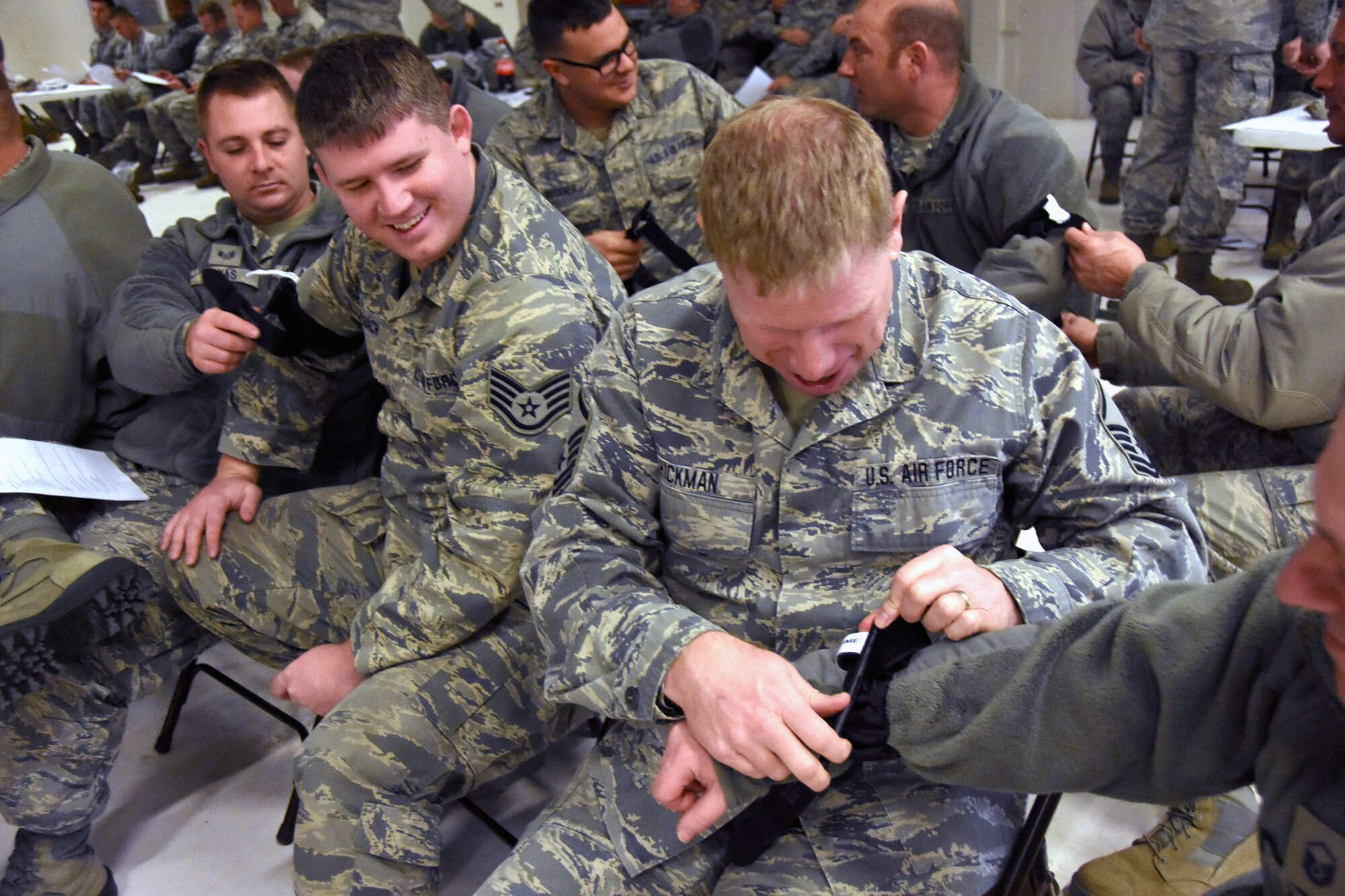 Staff Sgt. T.J. Seelbach and Master Sgt. Doug Hickman practice their self-aid and buddy care skills during the rodeo. (Photo by Staff Sgt. Kayla Köhn)