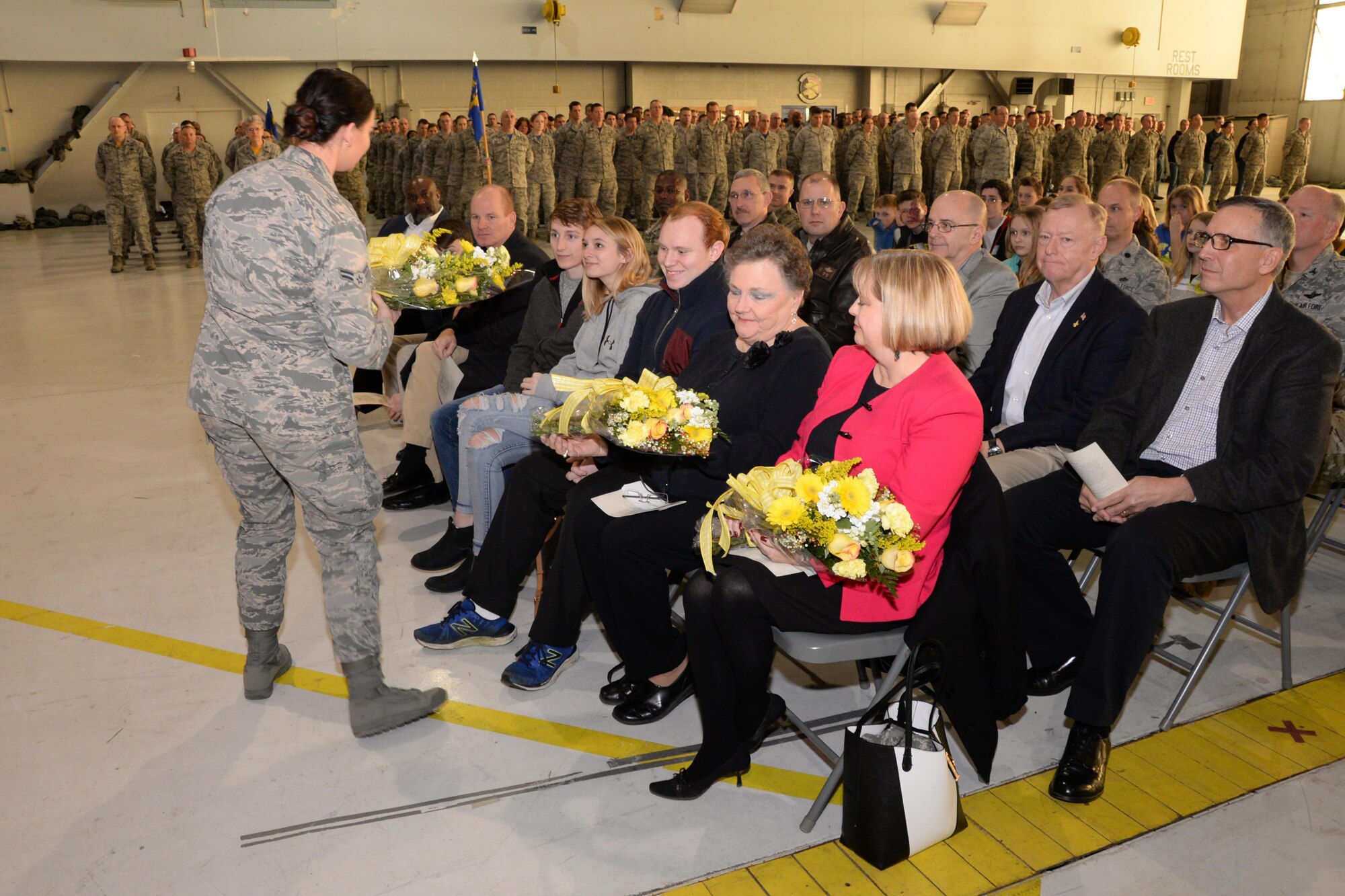 Family members of U.S. Air Force Col. Chris Alderdice receive flowers during an assumption of command ceremony Feb. 5, 2017, Hulman Field Air National Guard base, Terre Haute, Ind.. Col. Alderdice assumed command of the 181st Intelligence Wing. (U.S. Air National Guard photo by Senior Airman Lonnie Wiram)