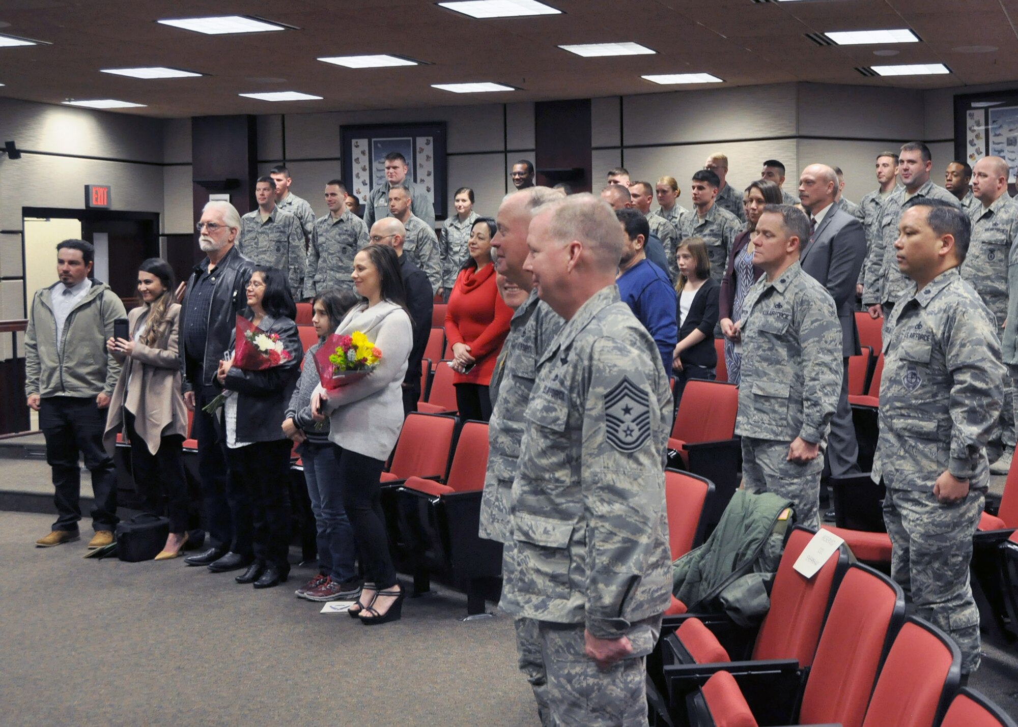 Citizen Airmen with the 931st Air Refueling Wing, friends, and family all rise for the arrival of the official party during the 931 SFS assumption of command ceremony Feb. 4, 2017, McConnell Air Force Base, Kan. Ceremonies such as this serve as official markers of the transfer of authority between commanders. (U.S. Air Force photo by Senior Airman Preston Webb)