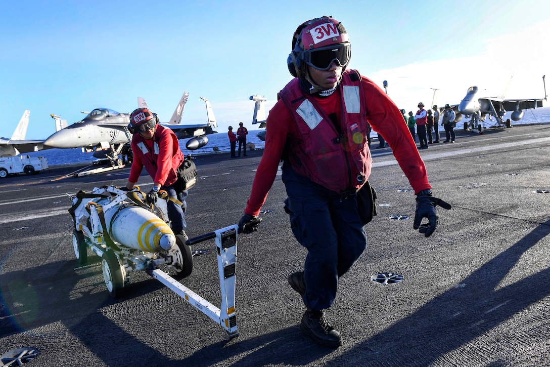 Navy Seamen Victor Cedomio, left, and Austin Slaughter transport a Mark 82/BLU 111 500-pound bomb on the flight deck of the aircraft carrier USS Carl Vinson in the Pacific Ocean, Jan. 30, 2017. Cedomio and Slaughter are aviation ordnanceman airman. The Carl Vinson Carrier Strike Group is on a regularly scheduled Western Pacific deployment as part of the U.S. Pacific Fleet-led initiative to extend the command and control functions of U.S. 3rd fleet. Navy photo by Chief Amanda Dunford
