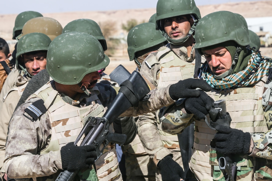 Iraqi security forces soldiers wait for react to contact training to begin at Al Asad Air Base, Iraq, Feb. 1, 2017. Training at building partner capacity sites is an integral part of Combined Joint Task Force – Operation Inherent Resolve’s effort to train ISF personnel.  CJTF-OIR is the global Coalition to defeat ISIL in Iraq and Syria.  (U.S. Army photo by Sgt. Lisa Soy)