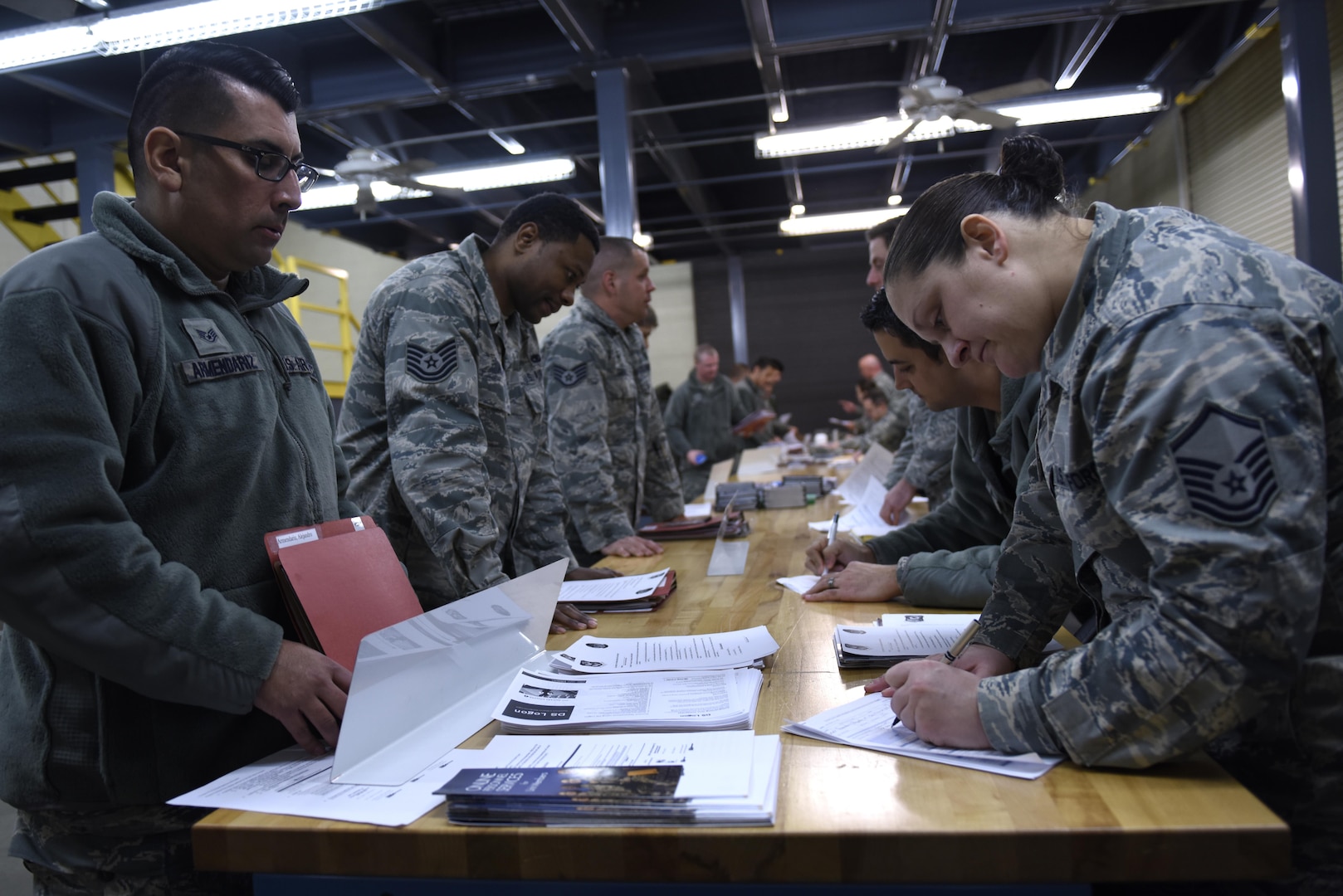 Air Force Tech. Sgt. Alejandro Armendariz, 145th Maintenance Squadron, has his deployment paperwork reviewed for the final time by Master Sgt. Tessa Miller, 145th Force Support Squadron, during a deployment processing line held at the held at the North Carolina Air National Guard Base, Charlotte Douglas International Airport, Feb. 5, 2017. Armendariz is a crew chief and is deploying for the first time.