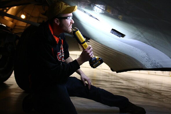 Senior Airman Matthew Card, 445th Maintenance Squadron, aerospace maintenance apprentice, performs a routine landing gear inspection on a C-17 Globemaster III here Jan. 23, 2017. (U.S. Air Force photo /Tech. Sgt. Patrick O’Reilly)