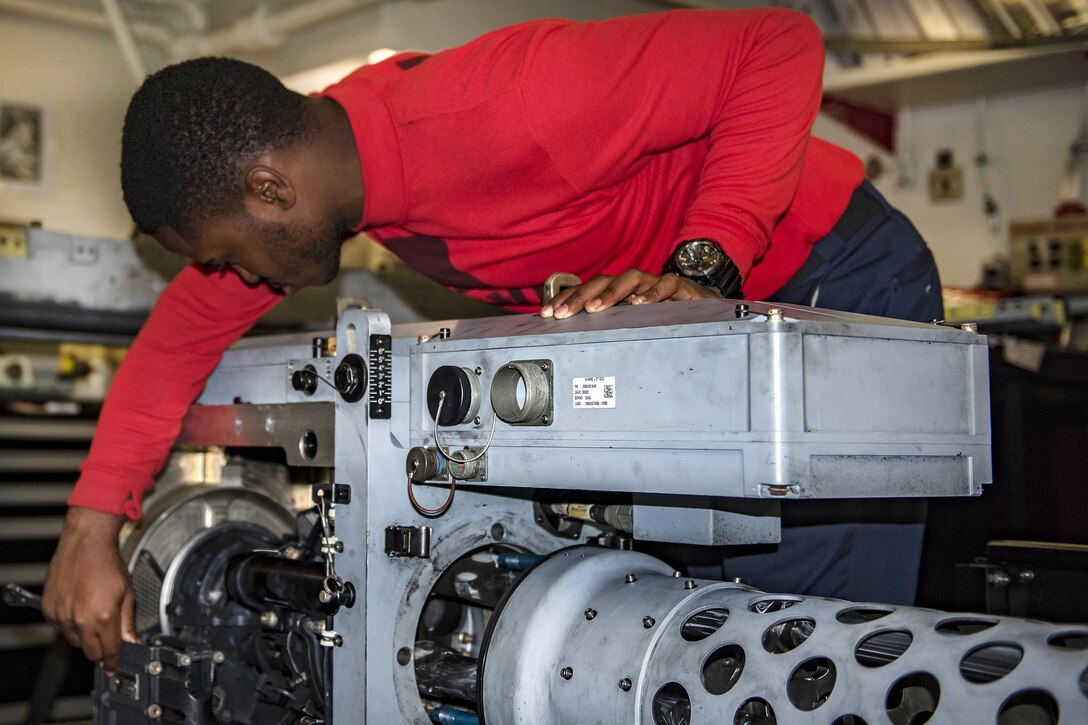 Navy Seaman Justin Walden performs maintenance on an A/A49E-27 anti-aircraft gun aboard the aircraft carrier USS Carl Vinson in the Pacific Ocean, Feb. 1, 2017. Walden is an aviation ordananceman airman. Navy photo by Seaman Jake Cannady