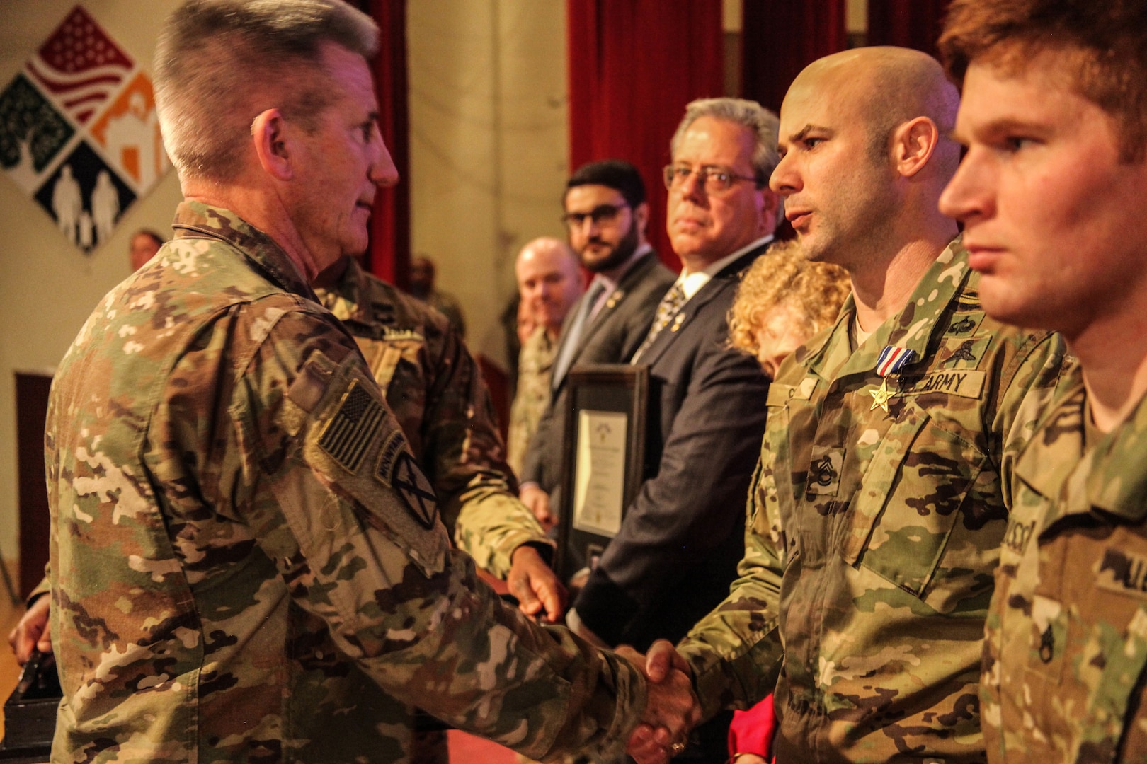 Gen. John Nicholson, commander of the Resolute Support mission and U.S. Forces-Afghanistan (Left), congratulates Sgt. 1st Class Brian Seidl, 10th Special Forces Group (Airborne), after presenting him with the Silver Star award on Fort Carson, Colo., Feb 1, 2017. Seidl earned the Silver Star for his heroic actions during the Battle of Boz Qandahari, Afghanistan on Nov. 2-3, 2016. (U.S. Army photo by Sgt. Connor Mendez/Reviewed)