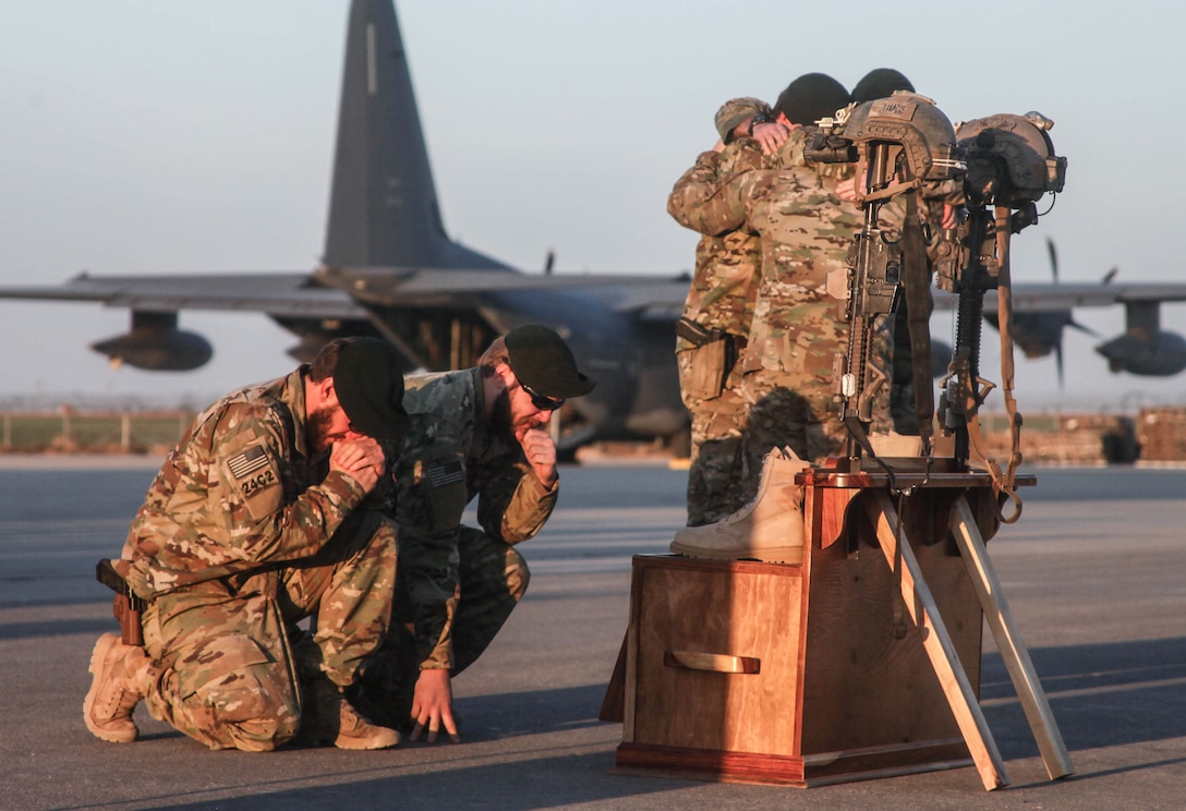 Soldiers of Special Forces Operational Detachment - Alpha 0224, 10th Special Forces Group (Airborne) memorialize two of their fallen brothers during a memorial held at Kunduz Airfield in Afghanistan on Nov. 7, 2016. Maj. Andrew Byers, the commander for ODA 0224, and Sgt. 1st Class Ryan Gloyer, an intelligence sergeant with ODA 0224, were killed in action during the Battle of Boz Qandahari, Afghanistan, on Nov. 2-3, 2016. (U.S. Army photo by Sgt. Connor Mendez/Reviewed)