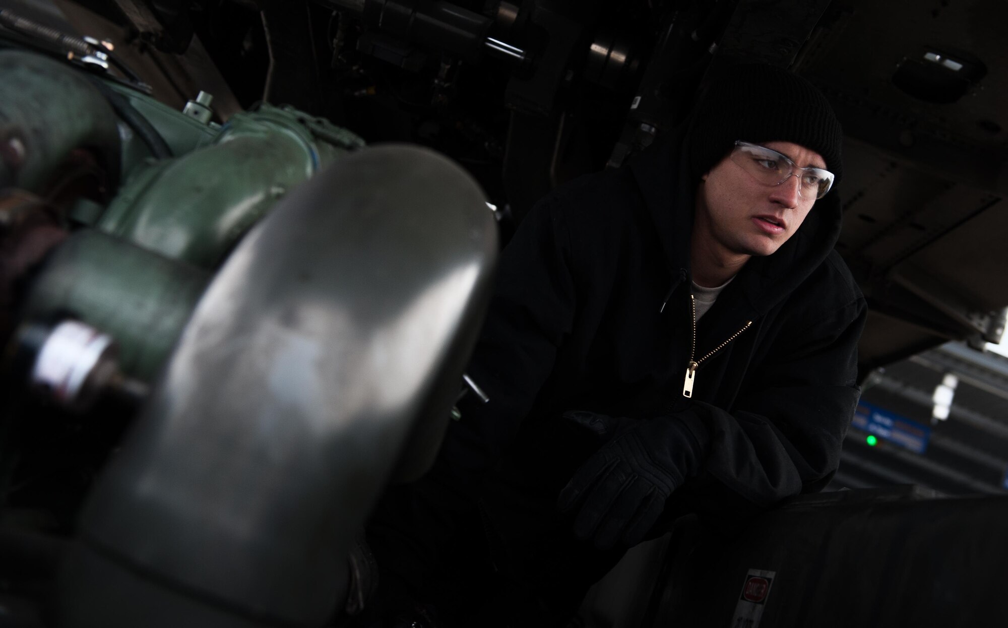 Airman 1st Class Brennan Gregory, 86th Vehicle Readiness Squadron special vehicle maintenance journeyman, waits for one of his coworkers to give him a tool on Ramstein Air Base, Germany, Jan. 30, 2017. As he began to diagnose the issue, Gregory found the layout of the starter and its surrounding parts incredibly difficult to gain access to because the dipstick was in the way of the mounting bolts. (U.S. Air Force photo by Airman 1st Class Lane T. Plummer)