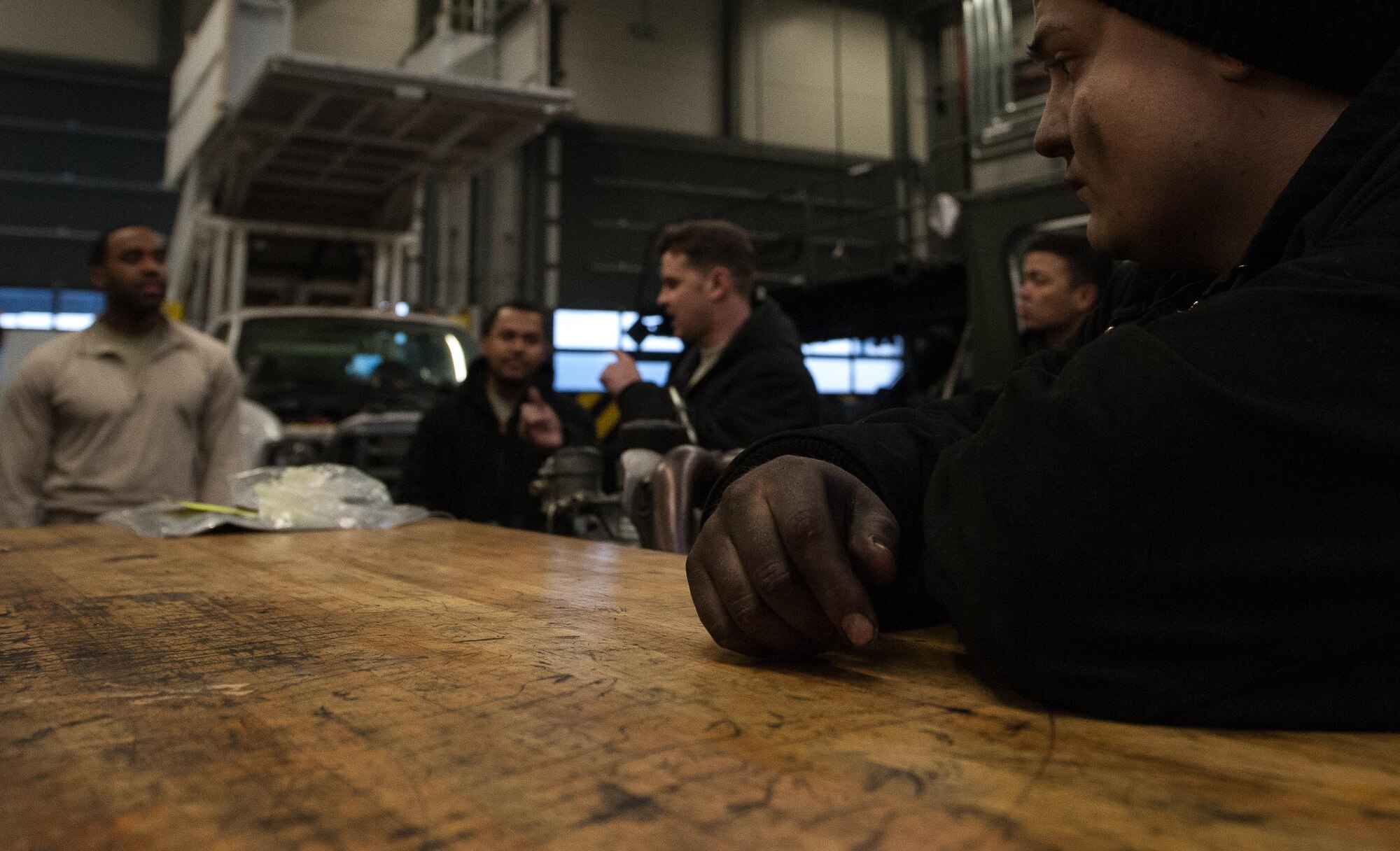 Airman 1st Class Dakota Staten, 86th Vehicle Readiness Squadron special vehicle maintenance journeyman, listens during a shop meeting at the end of the work day on Ramstein Air Base, Germany, Jan. 30, 2017. Every day, Airmen at the 86th VRS Special Vehicle Maintenance shop convene toward closing time and account for equipment and what was done during the day. (U.S. Air Force photo by Airman 1st Class Lane T. Plummer)