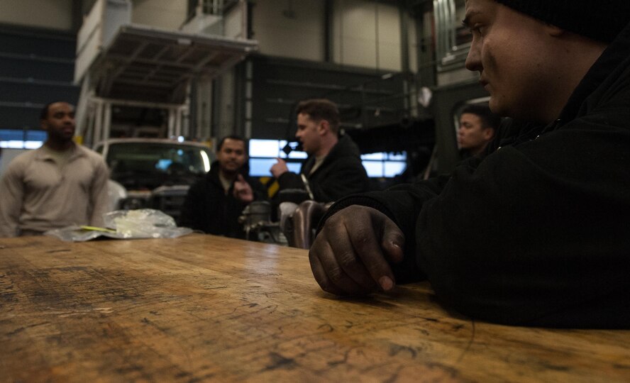Airman 1st Class Dakota Staten, 86th Vehicle Readiness Squadron special vehicle maintenance journeyman, listens during a shop meeting at the end of the work day on Ramstein Air Base, Germany, Jan. 30, 2017. Every day, Airmen at the 86th VRS Special Vehicle Maintenance shop convene toward closing time and account for equipment and what was done during the day. (U.S. Air Force photo by Airman 1st Class Lane T. Plummer)