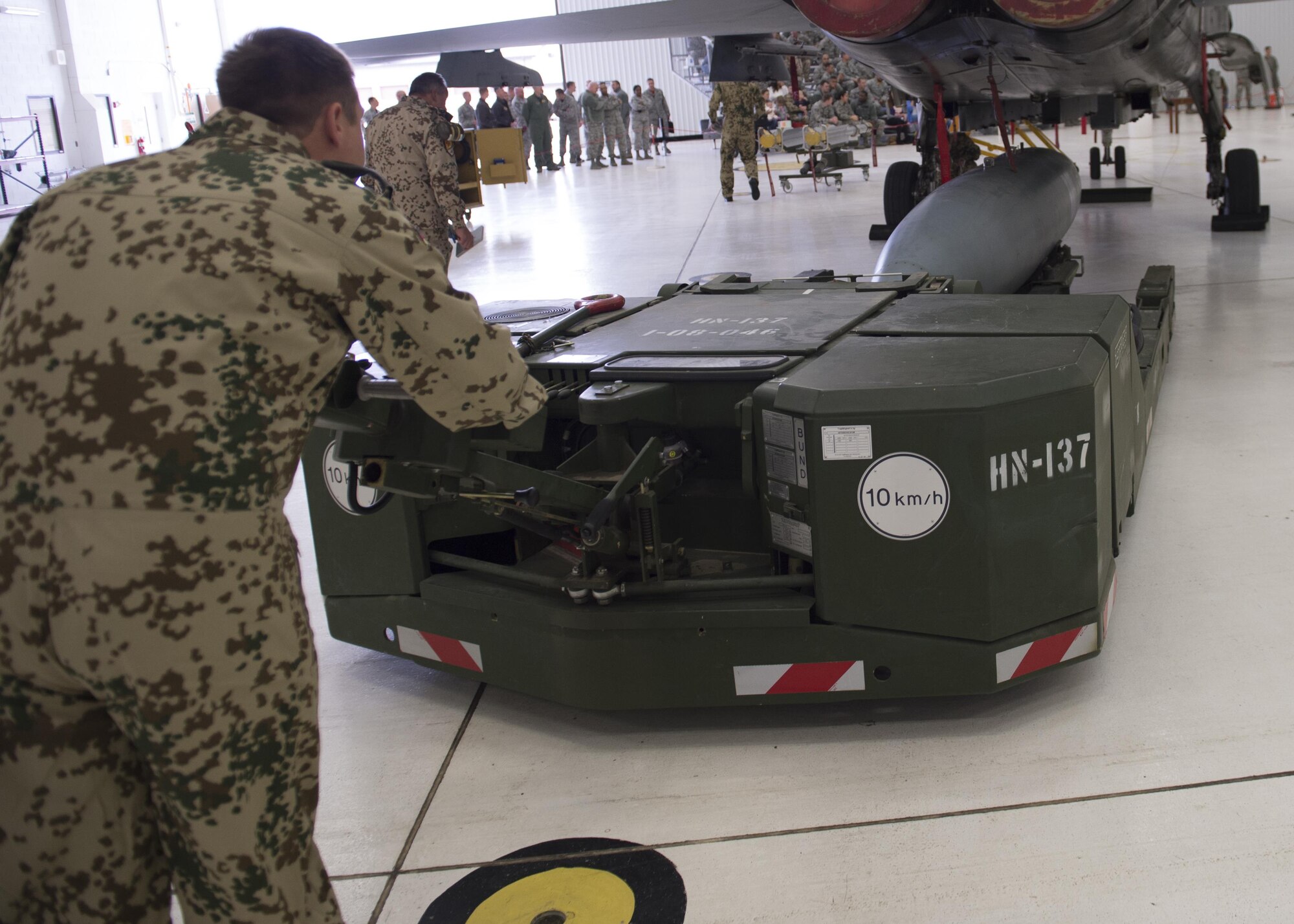 German Air Force Flying Training Center members load an inert munition onto a GAF Tornado during a quarterly load crew competition at Holloman Air Force Base, N.M., Jan. 20, 2016. The GAF competed for the last time in the load crew competition to have their skills evaluated alongside the MQ-9 Reaper and the F-16 Fighting Falcon load crews. Points for the competition are awarded based on weapons loading, tool kit inspection and uniform inspection categories. (U.S. Air Force photo by Senior Airman Chase Cannon/ Released)