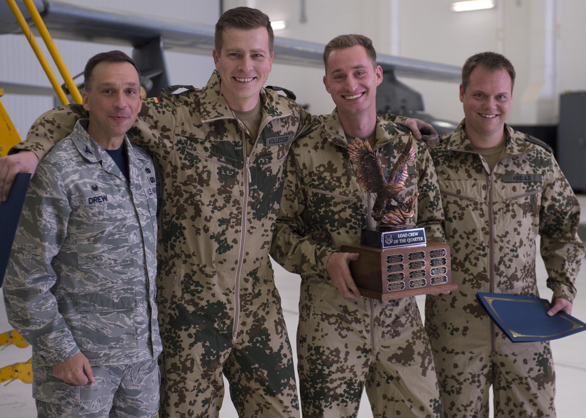 Col. Lyle Drew, 49th Maintenance Group commander, poses with the winning load crew from the German Air Force Flying Training Center following a load crew competition at Holloman Air Force Base, N.M., Jan. 20, 2017. The GAF competed for the last time in the load crew competition to have their skills evaluated alongside the MQ-9 Reaper, and the F-16 Fighting Falcon load crews. Points for the competition are awarded based on weapons loading, tool kit inspection and uniform inspection categories. (U.S. Air Force photo by Senior Airman Chase Cannon/ Released)
