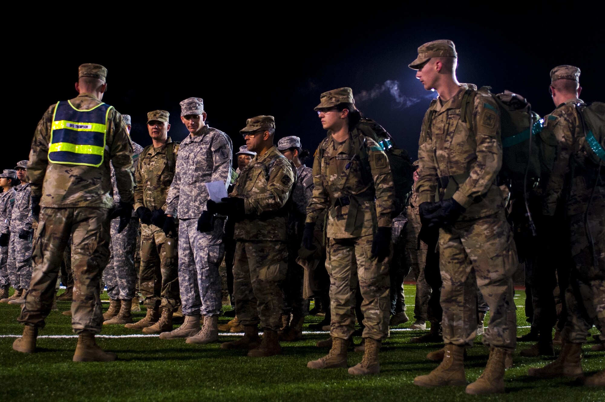 Soldiers of the 344th Military Intelligence Battalion receive a briefing while in formation before the beginning of the Fourth Annual Spartan Race at the Mathis Fitness Center football field on Goodfellow Air Force Base, Texas, February 3, 2017. The Spartan Race is a circuit, containing a 1.8-mile ruck march, a log carry around the track for 1 mile, body carries, 100 pullups, and a Humvee drag. (U.S. Air Force photo by Senior Airman Scott Jackson/Released)